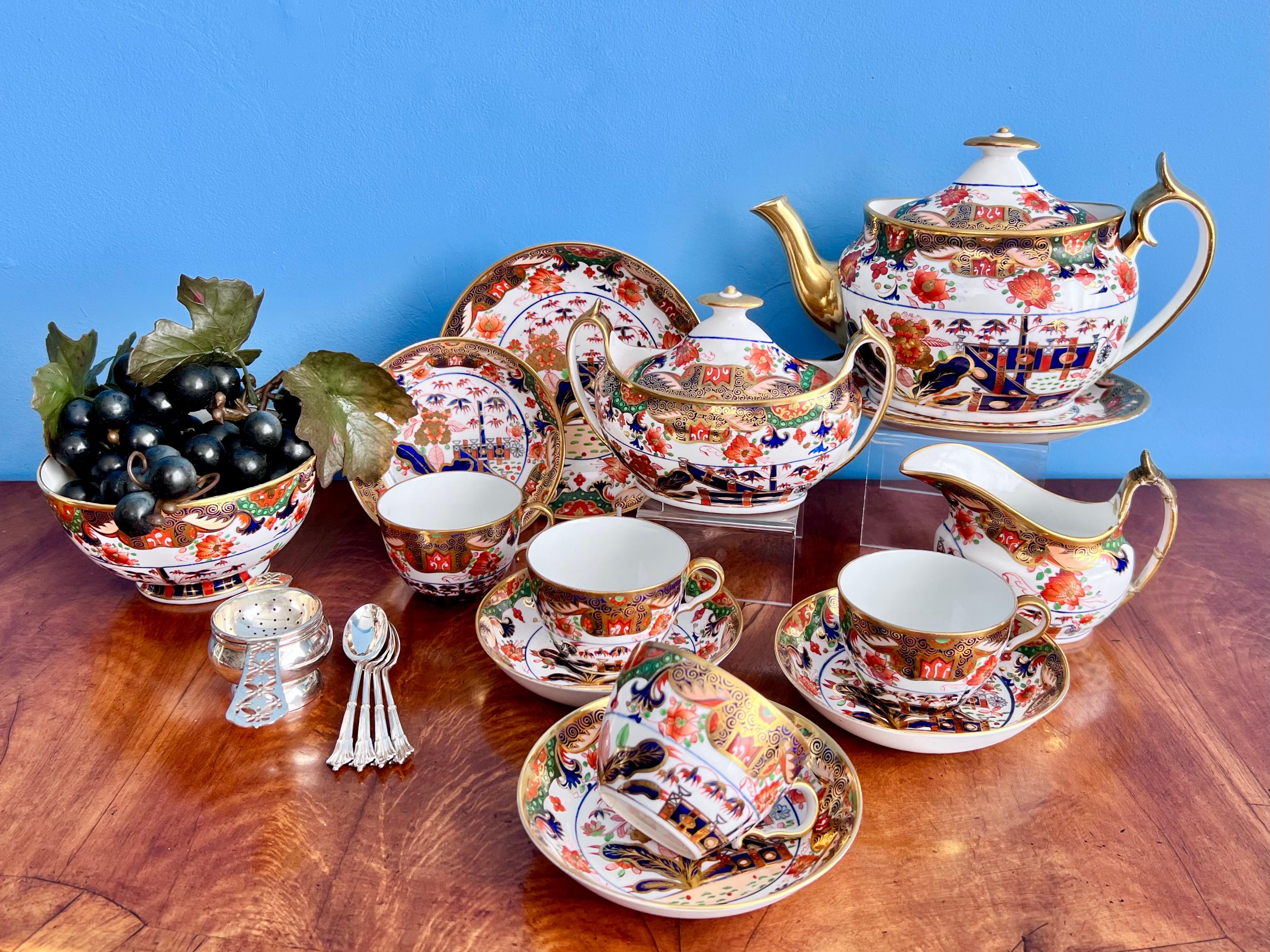 This is a stunning tea service made by Spode in about 1810, consisting of a large teapot with cover, a milk jug, a sucrier with cover, a slop bowl, a saucer dish and 4 teacups with saucers. The set is decorated with the famous Imari Tobacco Leaf