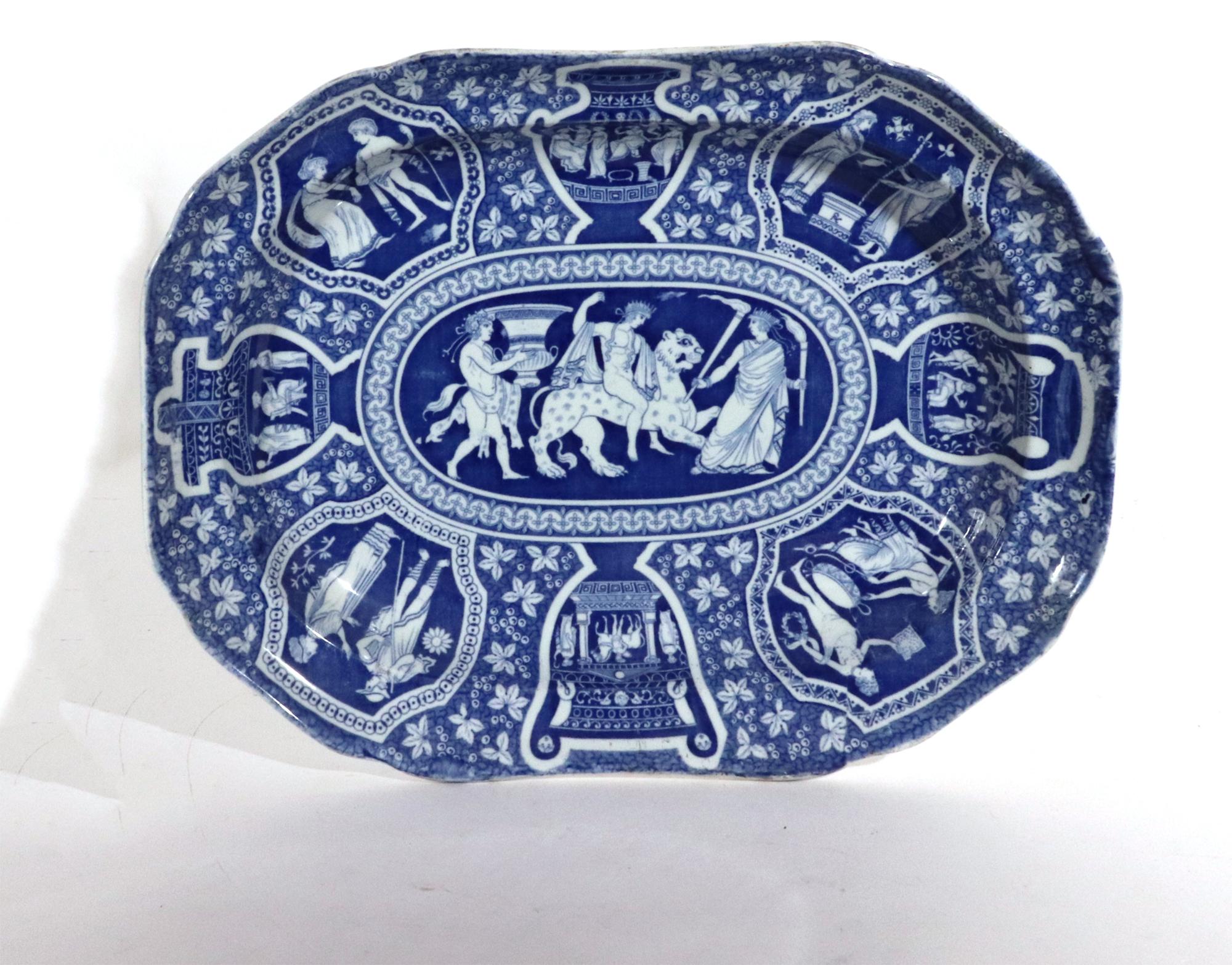 Spode pottery neo-classical Greek pattern blue deep dish,
Bacchus Mounted on a Panther,
Early-19th Century 

The Spode Greek pattern pottery shaped rectangular dish with cantered corners is printed in blue with neo-classical scenes on panels and