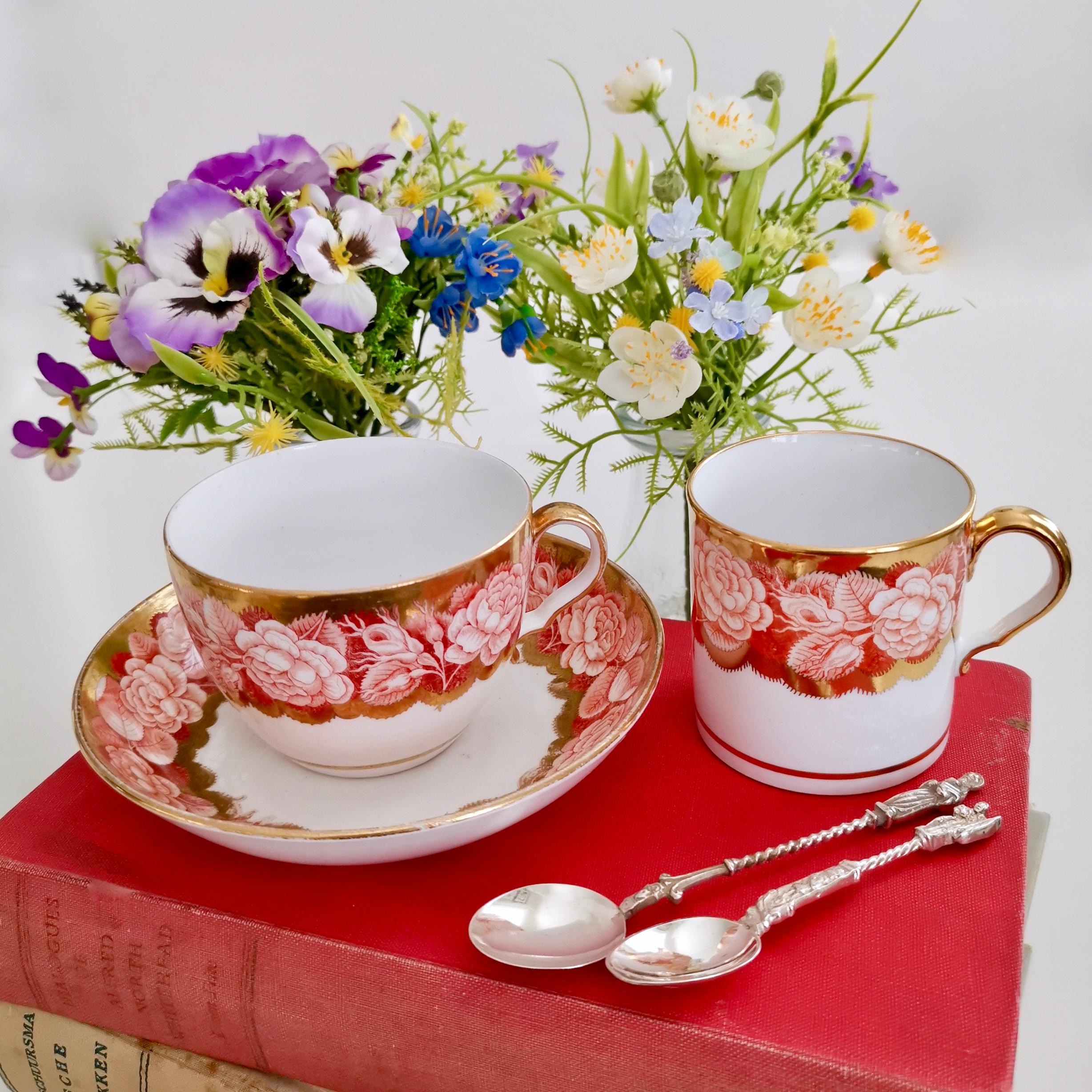 This is a beautiful trio consisting of a teacup, a coffee cup and a saucer, made by Spode in or shortly after 1806, which was the late Georgian period. It is decorated with the Rose Border in red, applied by pluck and dust printing. In the late 18th