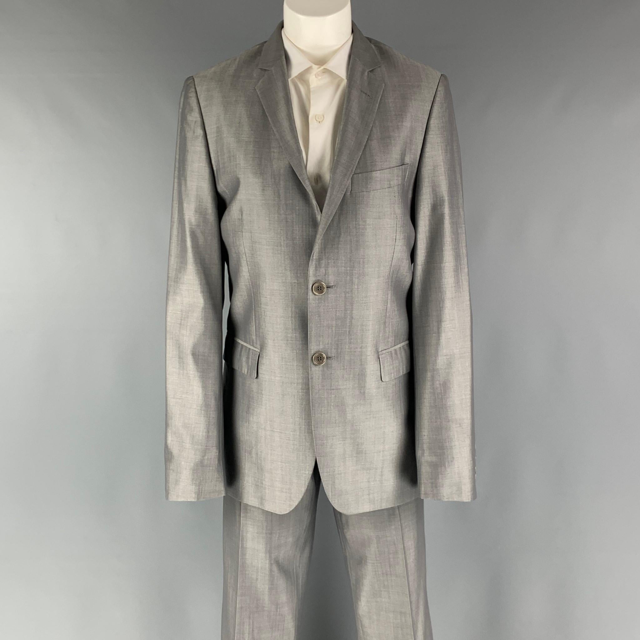 SPONTINI suit comes in a grey shimmery wool and silk woven material with a full liner and includes a single breasted, double button suit with a notch lapel and matching flat front trousers.

Excellent Pre- Owned Conditions.
Marked: