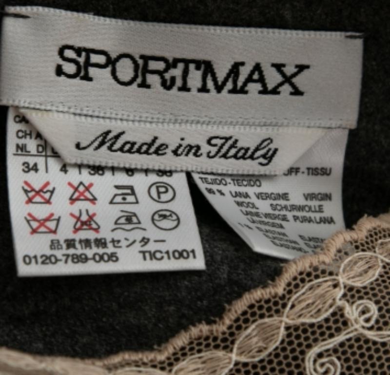 This top from Sportmax is here to make you look fashionable. It is tailored using grey wool fabric, which is highlighted with intricate white lace. It flaunts a sleeveless style and a zipper fastening.  Wear it with jeans and flats for casual