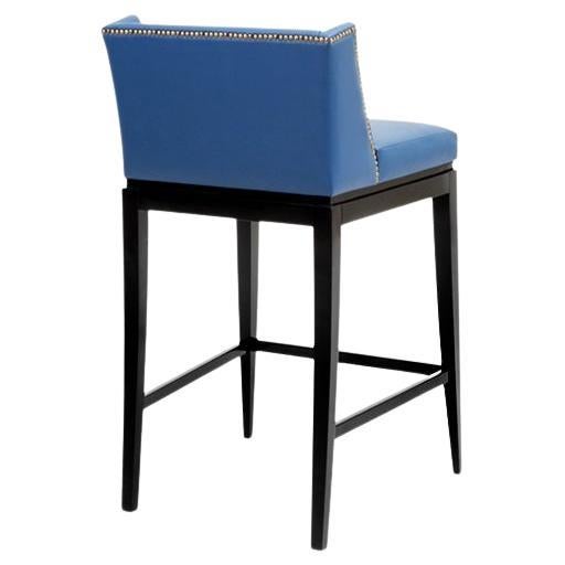 Sleek and refined, this counter stool boasts a robust structure. Customize it with a variety of stud colors for a classic, enduring touch. Crafted to order by our skilled artisans, the solid hardwood footer and padded seat with foam core and