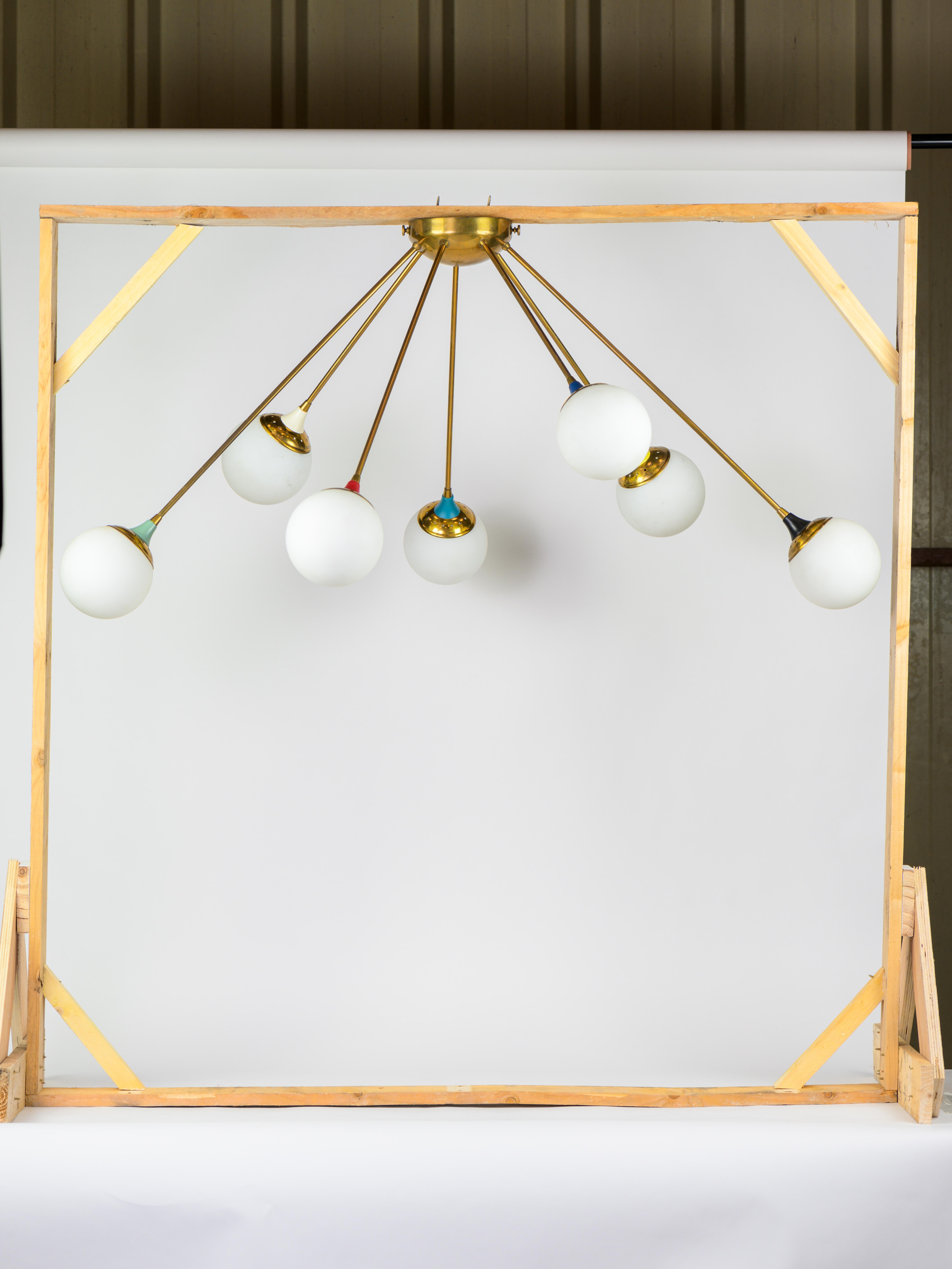 Spoutnik flush mount chandelier in brass, laquered metal and opaline glass. 

The colored details make it very particular. 

Italian work circa 1950. 

Good condition. 