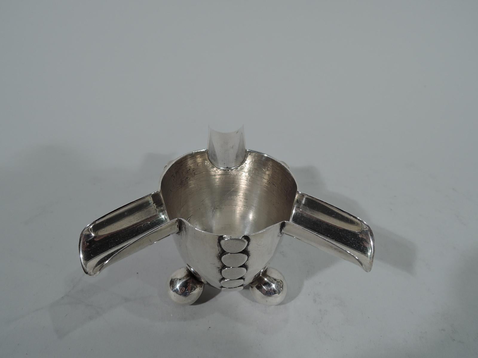 Mid-Century Modern sterling silver ashtray. Made by Spratling in Taxco, Mexico. Urn with 3 horizontal cradles and 3 ball supports. Three rows of circles applied vertically to exterior. A funny, anthropomorphic design, suggestive of a headless human,