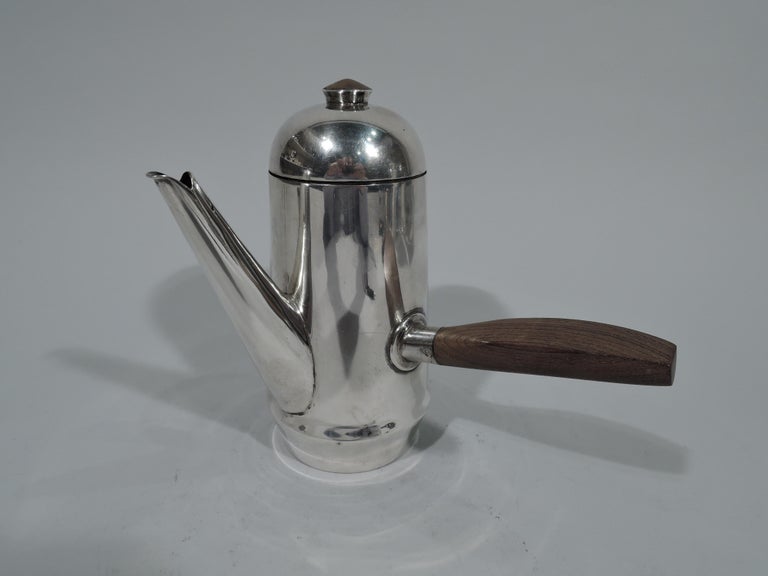 Mid-Century Modern sterling silver coffee set. Made by Spratling in Taxco, Mexico. This set comprises coffeepot, creamer, and sugar.

Coffeepot: Gently upward tapering sides, straight diagonal spout, and hinged and domed cover with cabochon