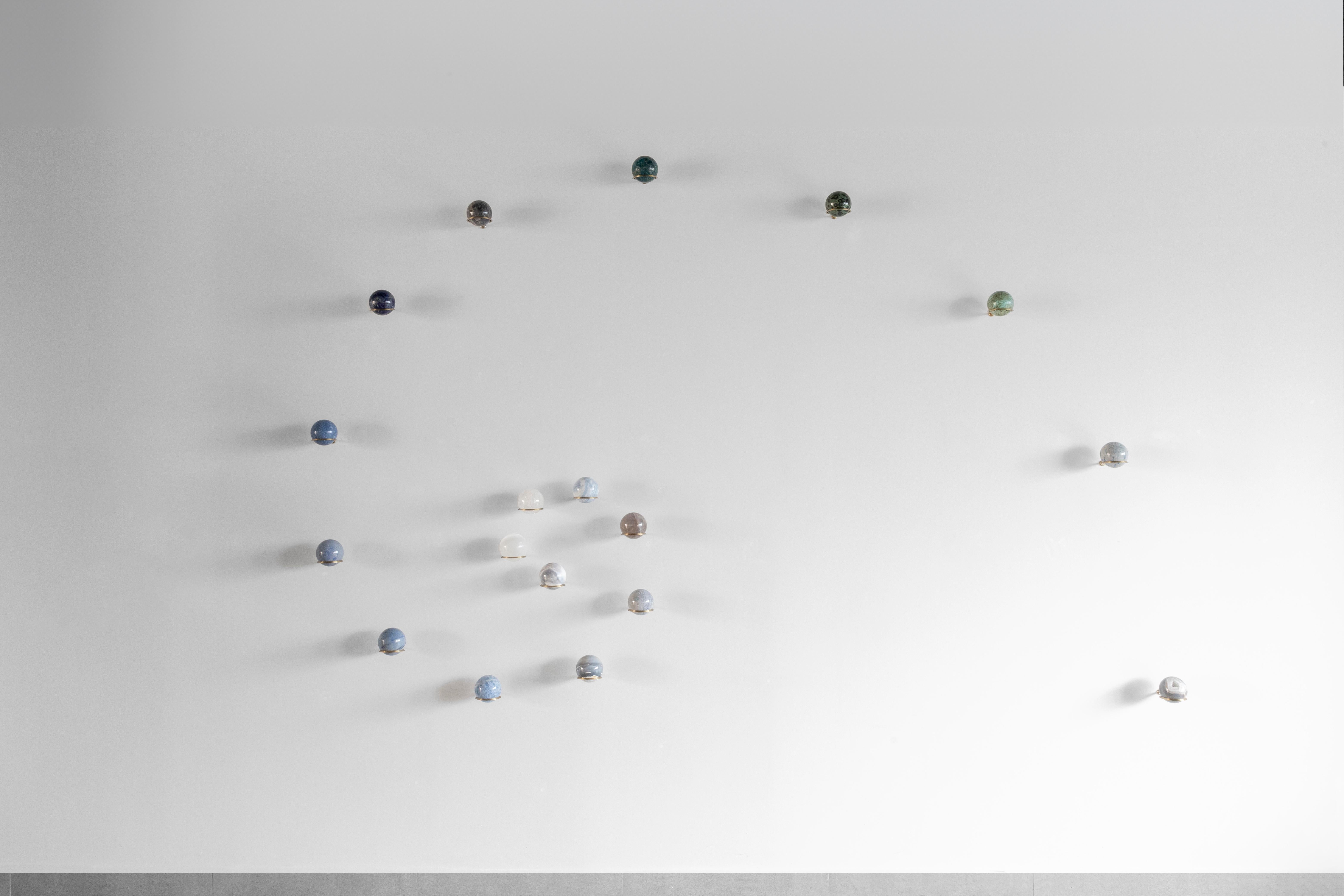 Semi-precious stones, brass holder
Edition of 5
Set of 18 spheres

**We can custom color pallet in the composition**
***Colors and textures may vary due the uniqueness of the stones***

Galaxies are systems where stars, dust, and dark matter are