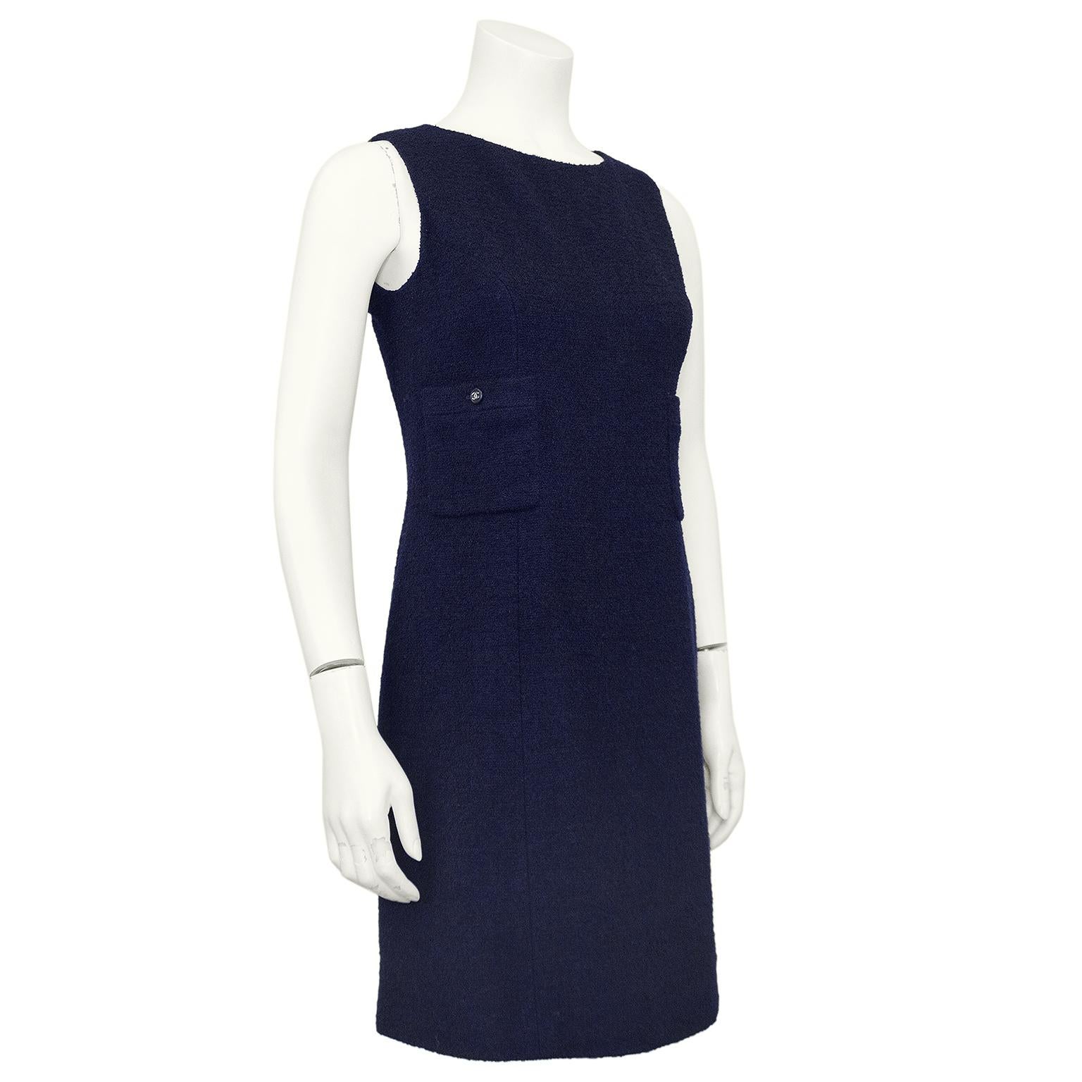 Classic and always effortlessly chic Chanel navy blue wool boucle dress from the Spring 1996 collection. Sleeveless with a high boat neckline, centre seam and patch pockets with black and silver interlocking cc logo buttons. Invisible zipper up