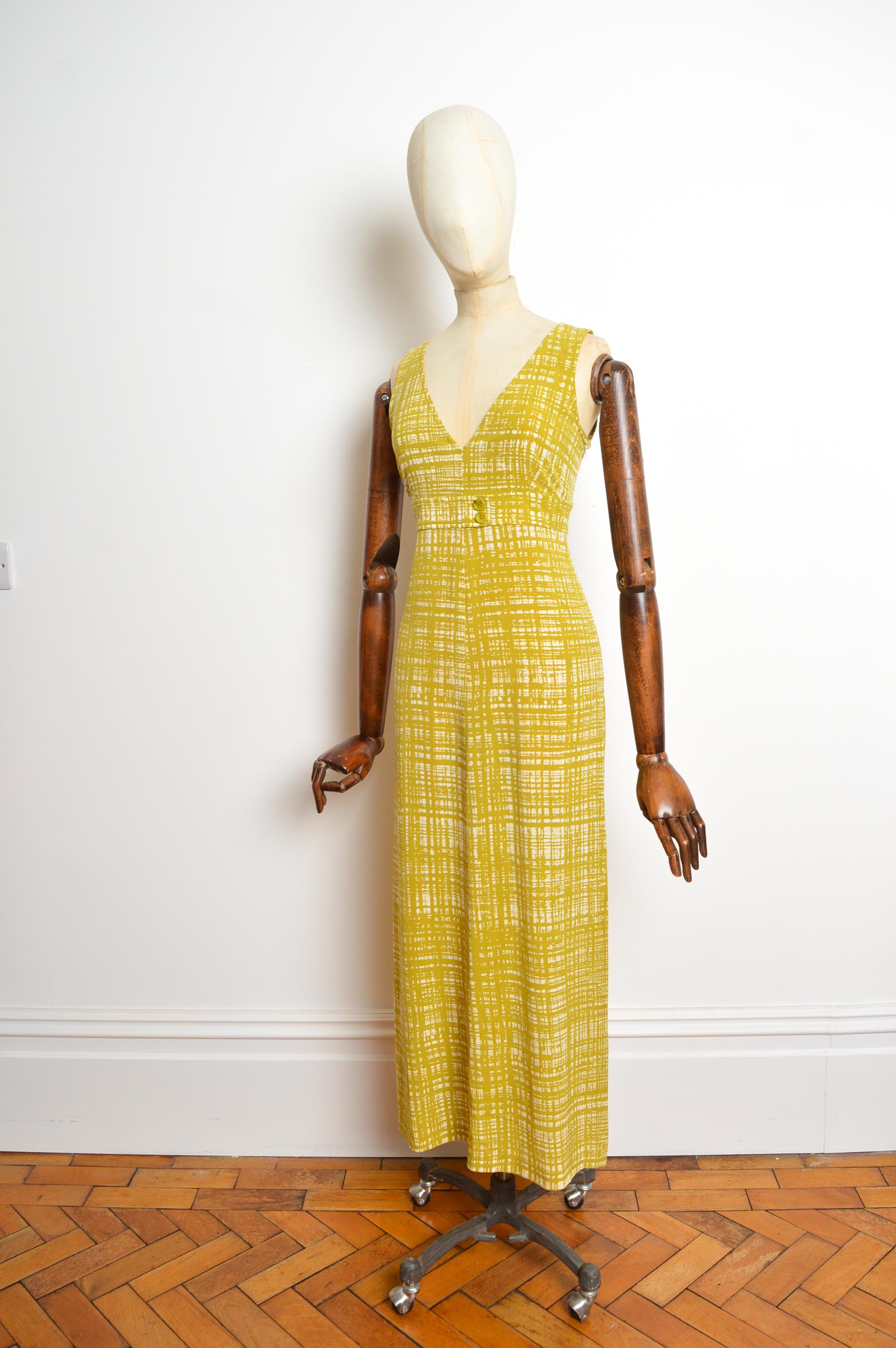 Spring / Summer 1996 PRADA dress, featuring an abstract print in Chartreuse and White, with buttons under the bust, V-neck line and Ankle length hem. 
Size; Recommended U.K. 6-8
Measurements are provided in inches (‘’)
Pit to Pit; 17”
Nape to Hem;