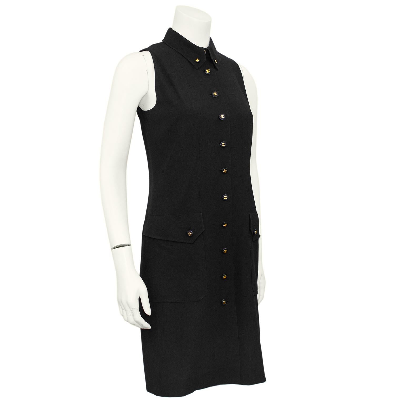 A classic and sleek Chanel sleeveless shirtdress from Spring 1997. Black crepe with small black and gold interlocking CC logo buttons down the centre front and on the large patch flap pockets. Black Chanel logo silk lining. Timeless and elegant, can