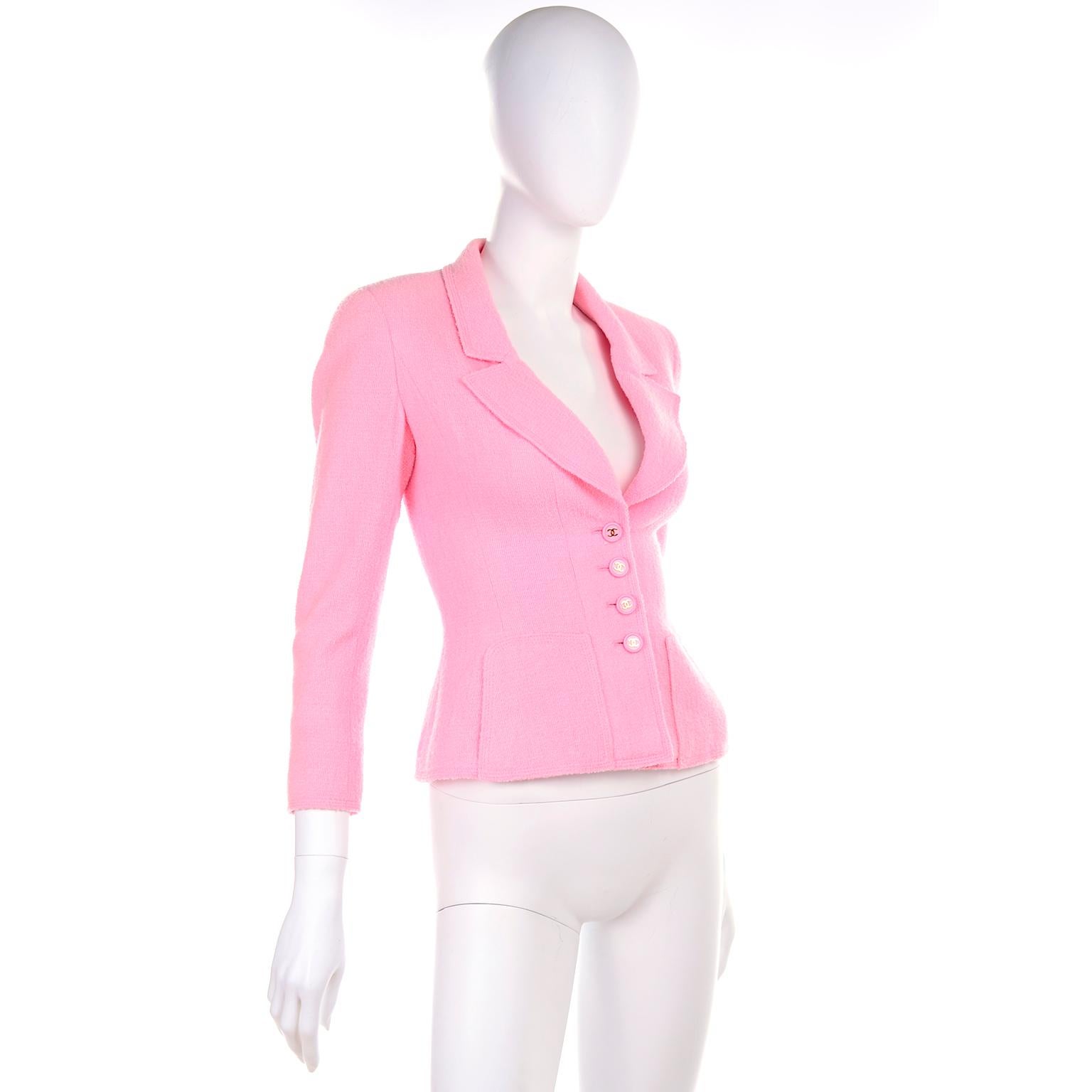 This beautiful vintage Chanel jacket is from the Spring Summer 1997 collection designed by Karl Lagerfeld.  The jacket has front side slit pockets, and zippers on the sleeves with CC Chanel monogram zipper pulls, Chanel pink marked buttons (4
