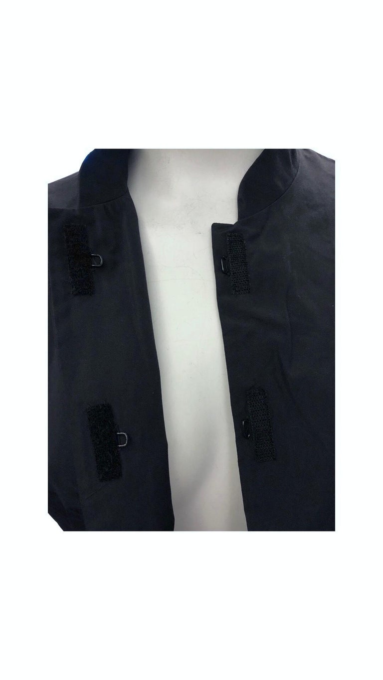 - Spring 1998 Prada black silk mandarin collar sleeveless top.

- Velcro and hook closure. 

- 100% Silk. 

- Size 44. 




