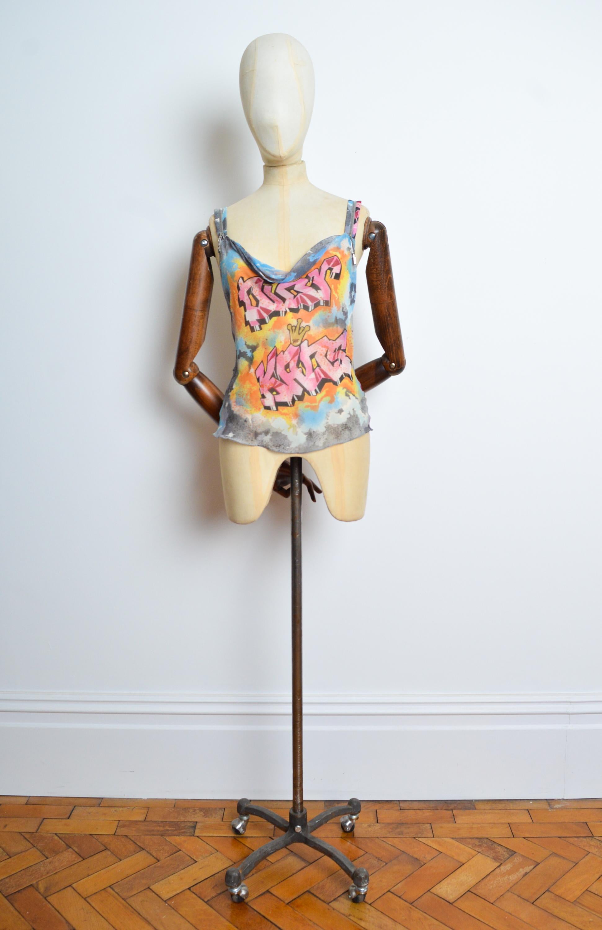 Spring 2003 Christian Dior by John GALLIANO silk camisole with iconic Graffiti print detail. Sunset Colours and zip detail straps with the Dior Breloque charm. 
Size; Recommended size Small / UK 6.
Measurements are provided in inches (‘’)
Pit to
