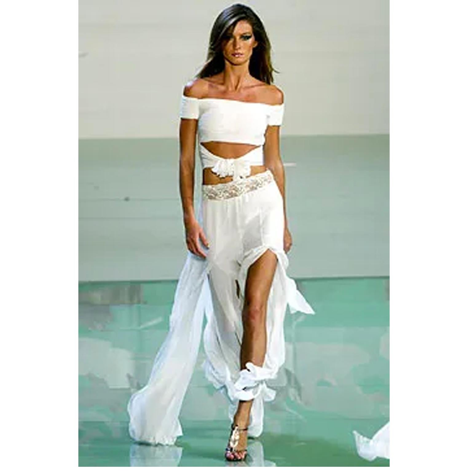 This sublime Valentino ivory silk off shoulder runway cropped top was designed by Valentino Garavani for the Valentino Spring/Summer 2003 collection. This incredible blouse is fully ruched and closes with a concealed zipper at the center back that