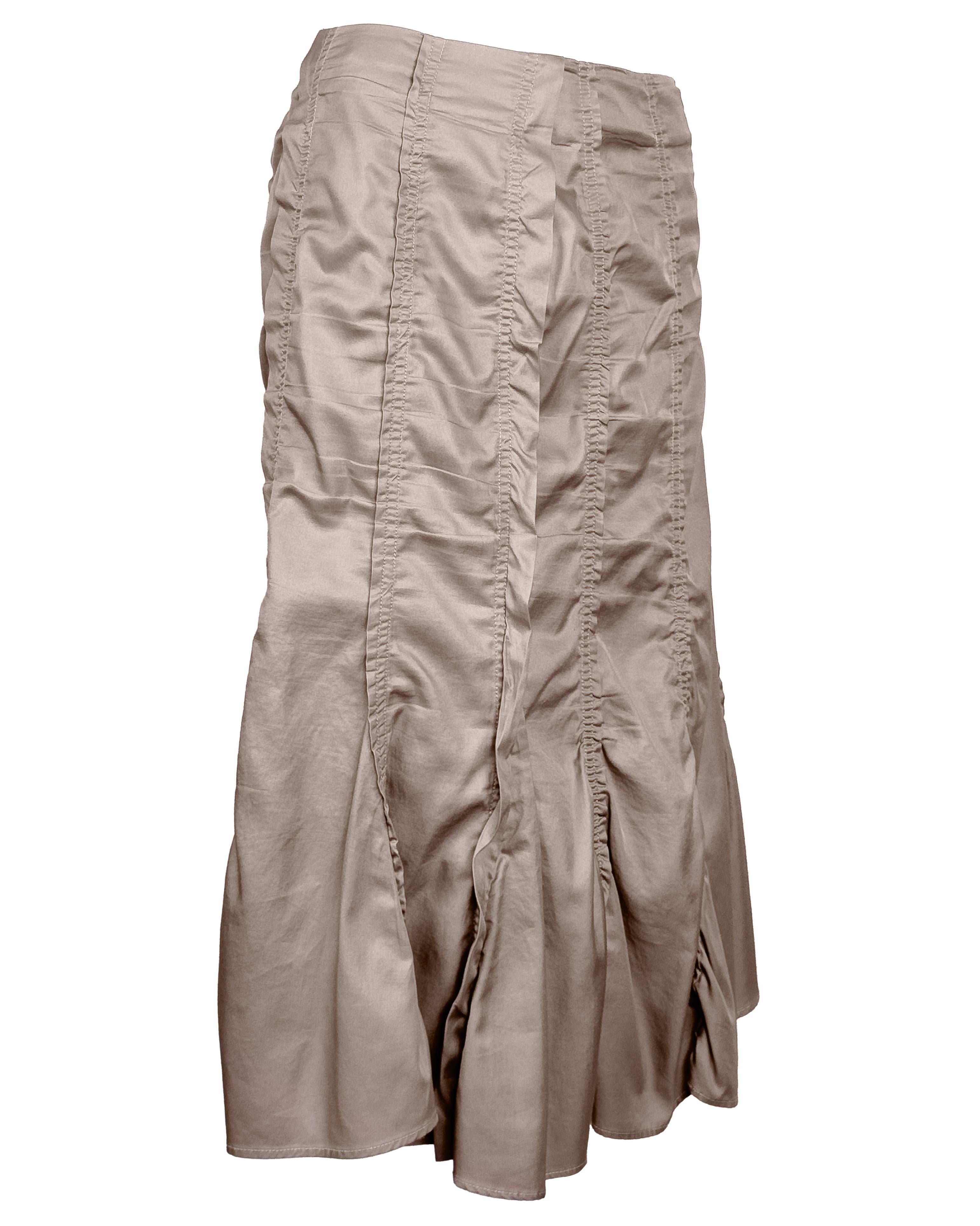Gathered panel skirt from Tom Ford’s Spring 2003 collection for Yves Saint Laurent Rive Gauche. Executed in a soft, muted taupe cotton twill, the design showcases Ford’s deft hand at transforming simple silhouettes into sculptural statements.