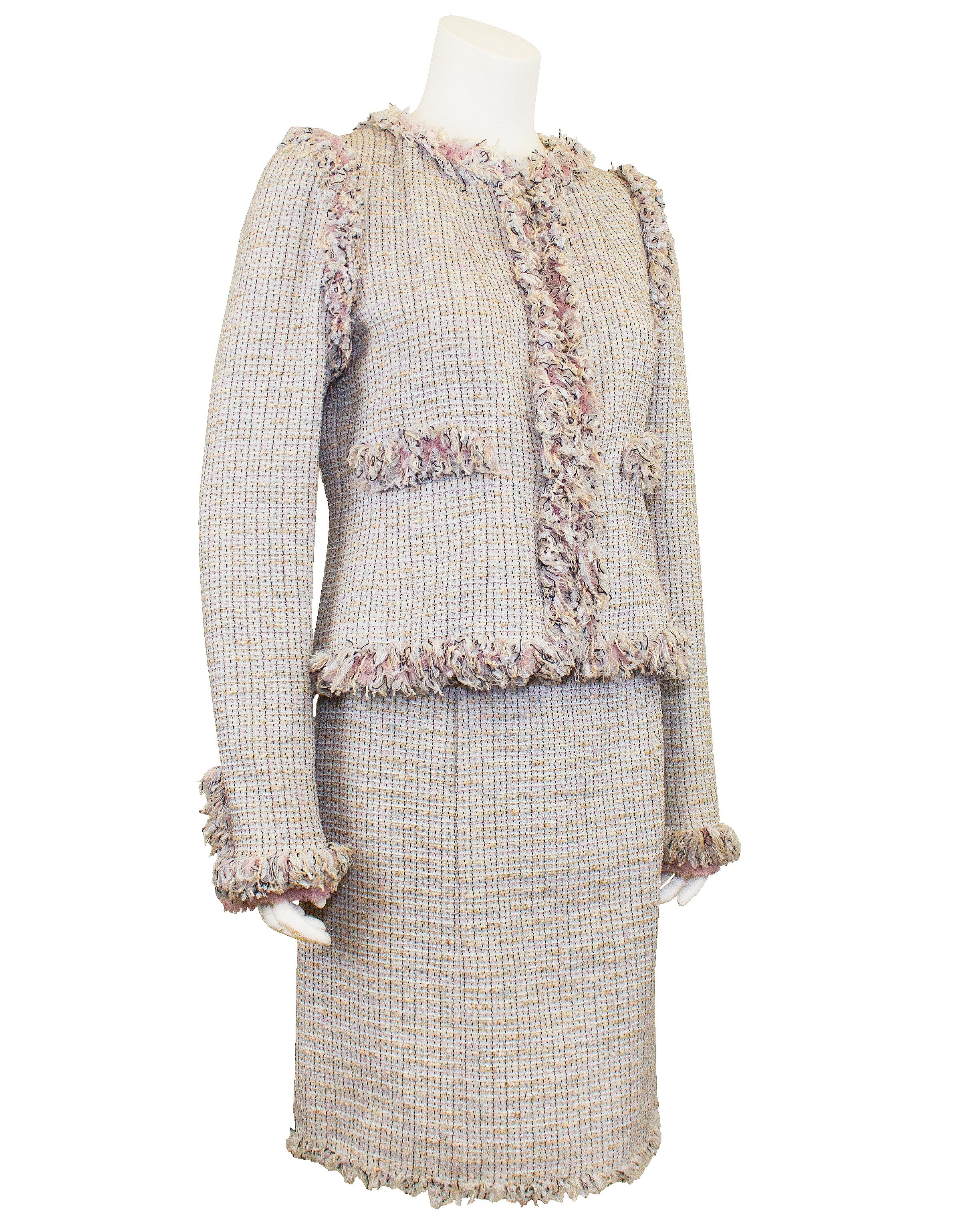 Chanel tweed skirt suit from the Spring 2004 collection. This is a slightly paired down version from the version presented on the runway. Crafted from a lightweight pale pink, pale blue, black and beige tweed, this suit is perfect for the Spring and