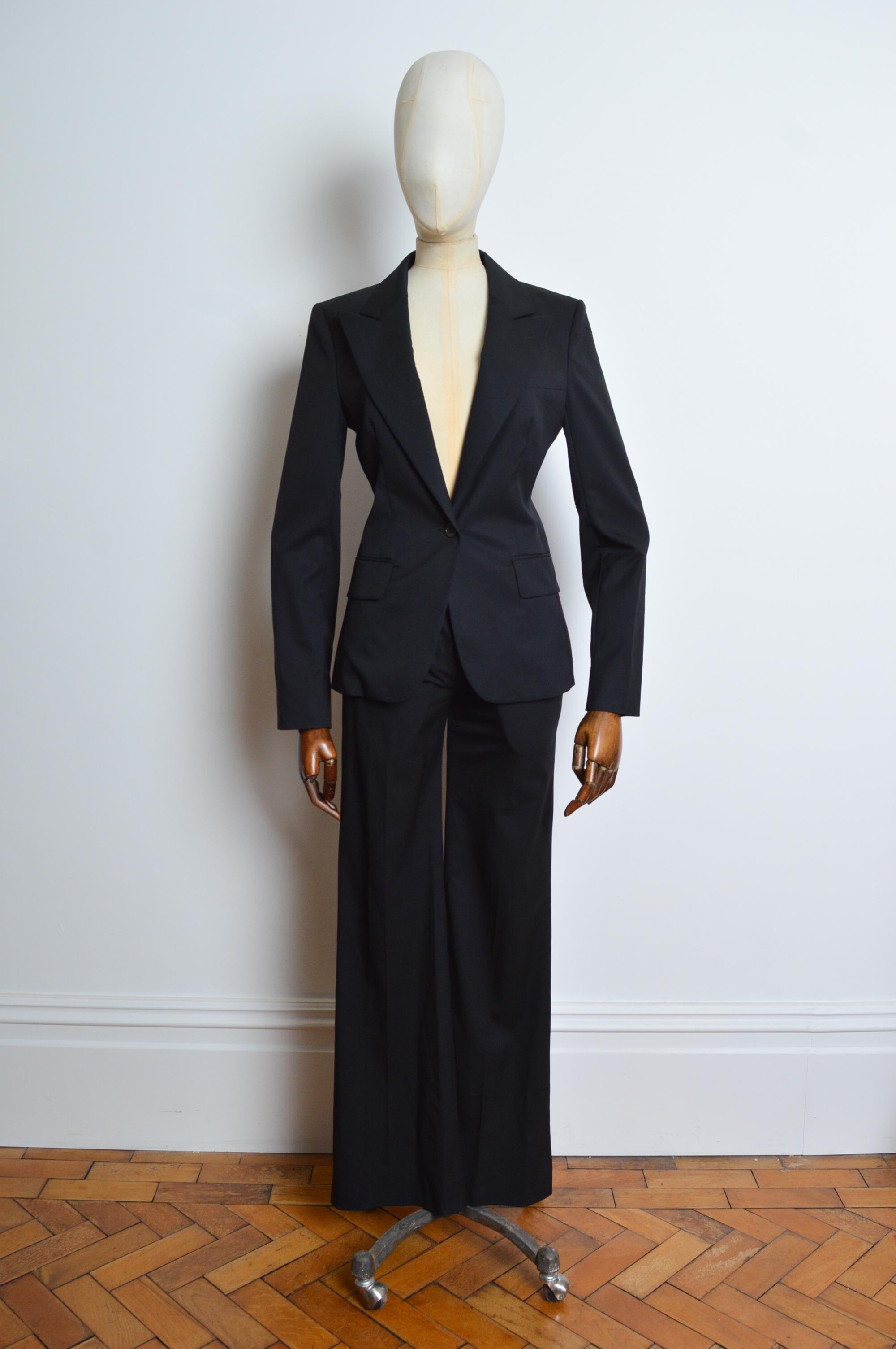 Superb Spring 2004 YSL by TOM FORD comprising a Fitted single button closure low cut blazer and chic slouchy matching tailored pants ! 
Recommended Size UK 6. 
Measurements provided in inches:
Jacket -
Pit to Pit; 17”
Pit to Cuff; 19”
Nape to Hem;