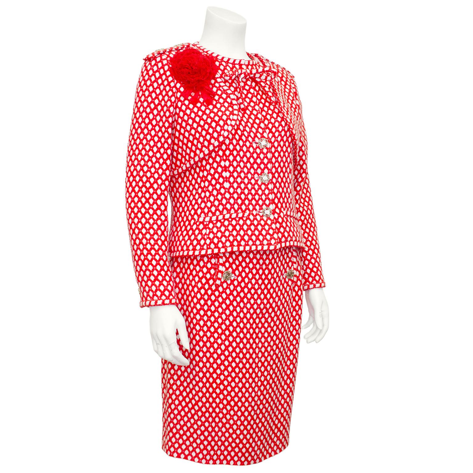 Stunning Chanel skirt suit from the Spring 2008 collection. Vibrant red and white tweed that almost looks like a trellis from a distance. Jacket is collarless with a bow at neckline. Epaulets with silver CC logo buttons featuring a shield motif. Cut