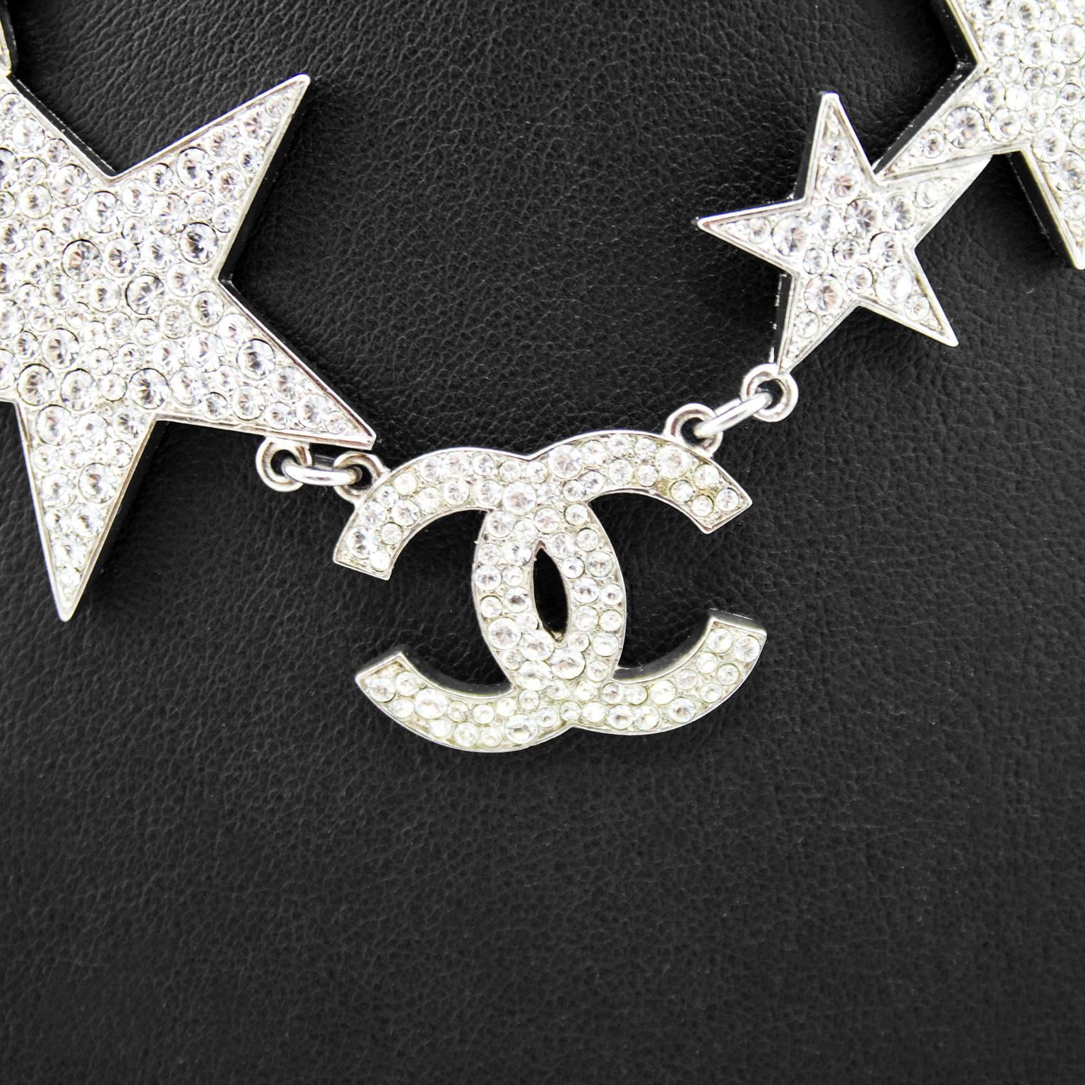 Fabulous Chanel silver metal star choker from the spring 2008 collection. Eleven different sized stars filled with rhinestones lay asymmetrically across the neck with a rhinestone encrusted cc logo just off middle. Tiny chain link wraps around the