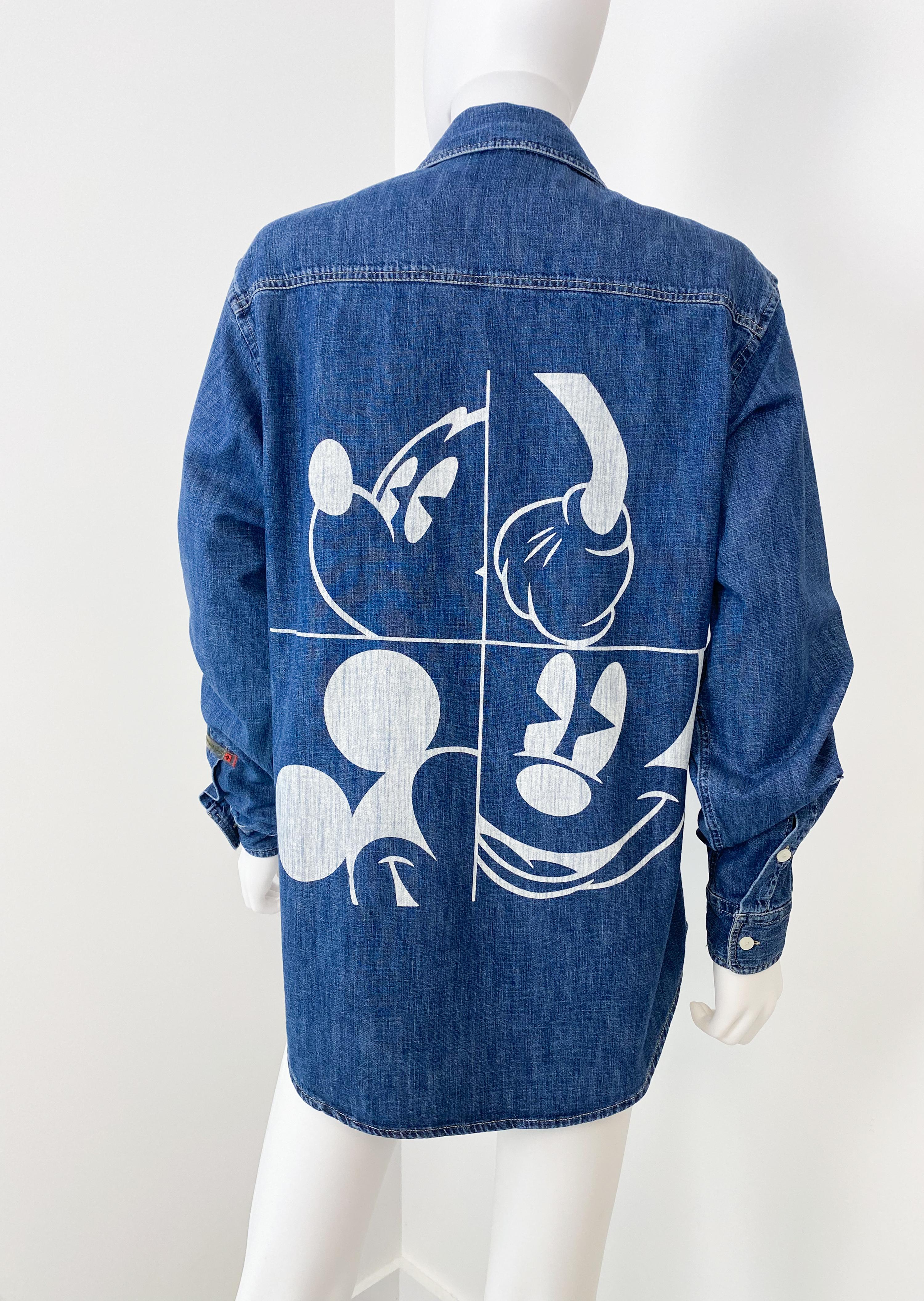 This is a rare 2012 Spring collection blue denim shirt by Jean-Charles de Castelbajac. Unisex style, it will fit men size S and women size L/XL. Stylized Disney Mickey Mouse painted design at the back (Disney copyright label on the inside). The