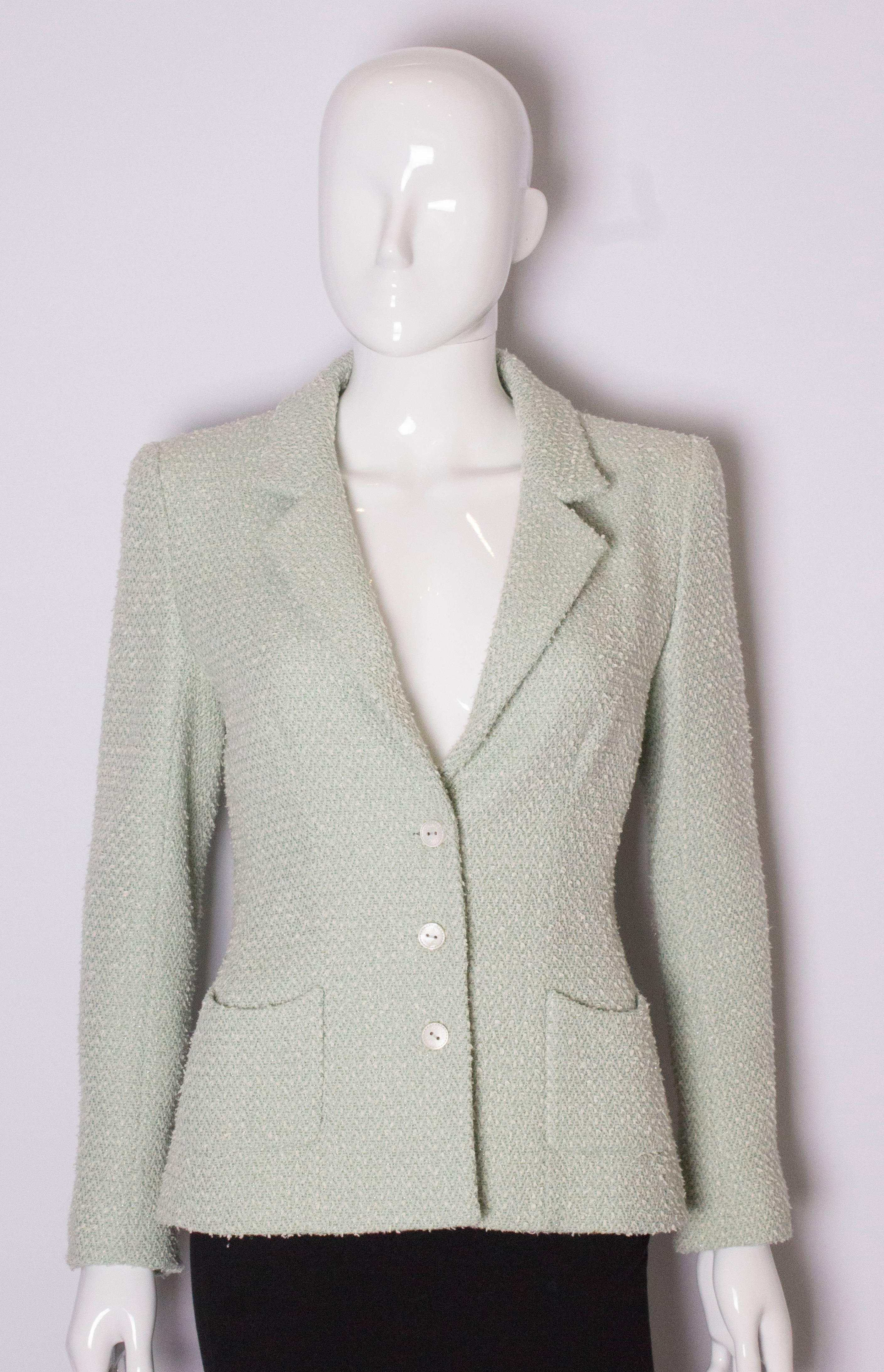 A pretty green jacket by Chanel.  The jacket is sage green with cream tuffs, and is a wool mix with silk lining. It has a v neckline and collar, 3 button front , single button cuffs and 2 pockets.
The jacket is lined in silk.