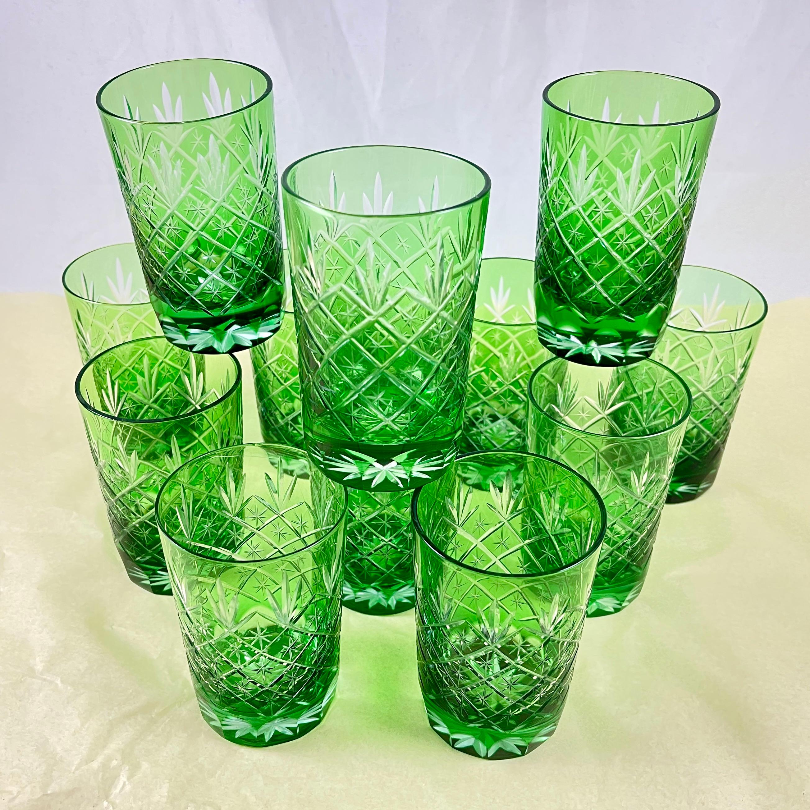 A Set of twelve Czech crystal glasses cased in a bright Spring Green, cut to clear, circa Mid – 20th Century.

Vintage Bohemian style tumblers or rocks glasses, hand cut in a rich, vibrant color to reveal a pattern of stars set in a diagonal grid.
