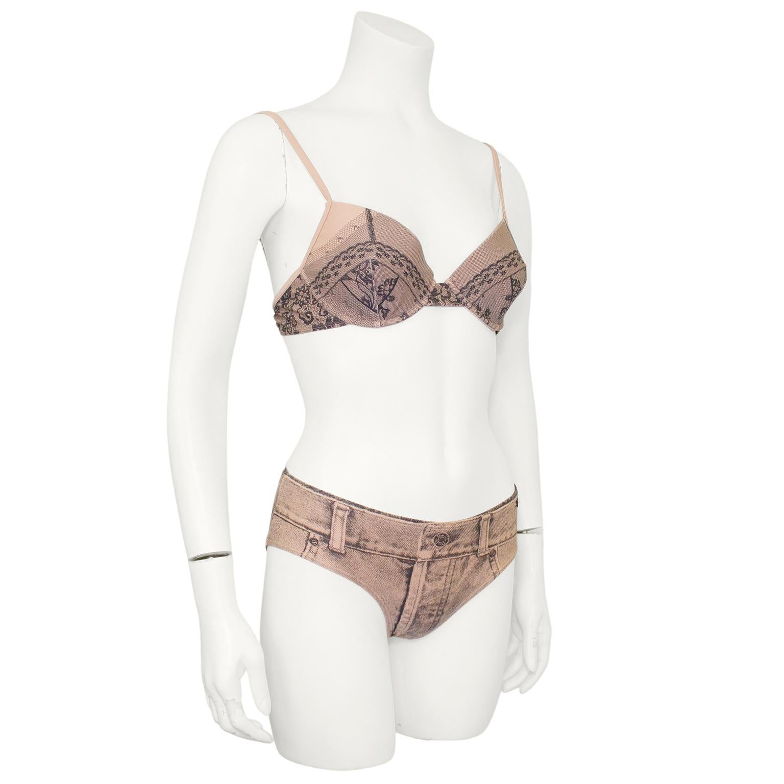 Dior bikini from Spring/Summer 2006. Muted peach colour with trompe l'oeil printed lace on the top and denim on the bottoms. Balconette style top with underwire and a heavy silver metal Dior engraved horizontal snap clasp. Classic mid rise bikini