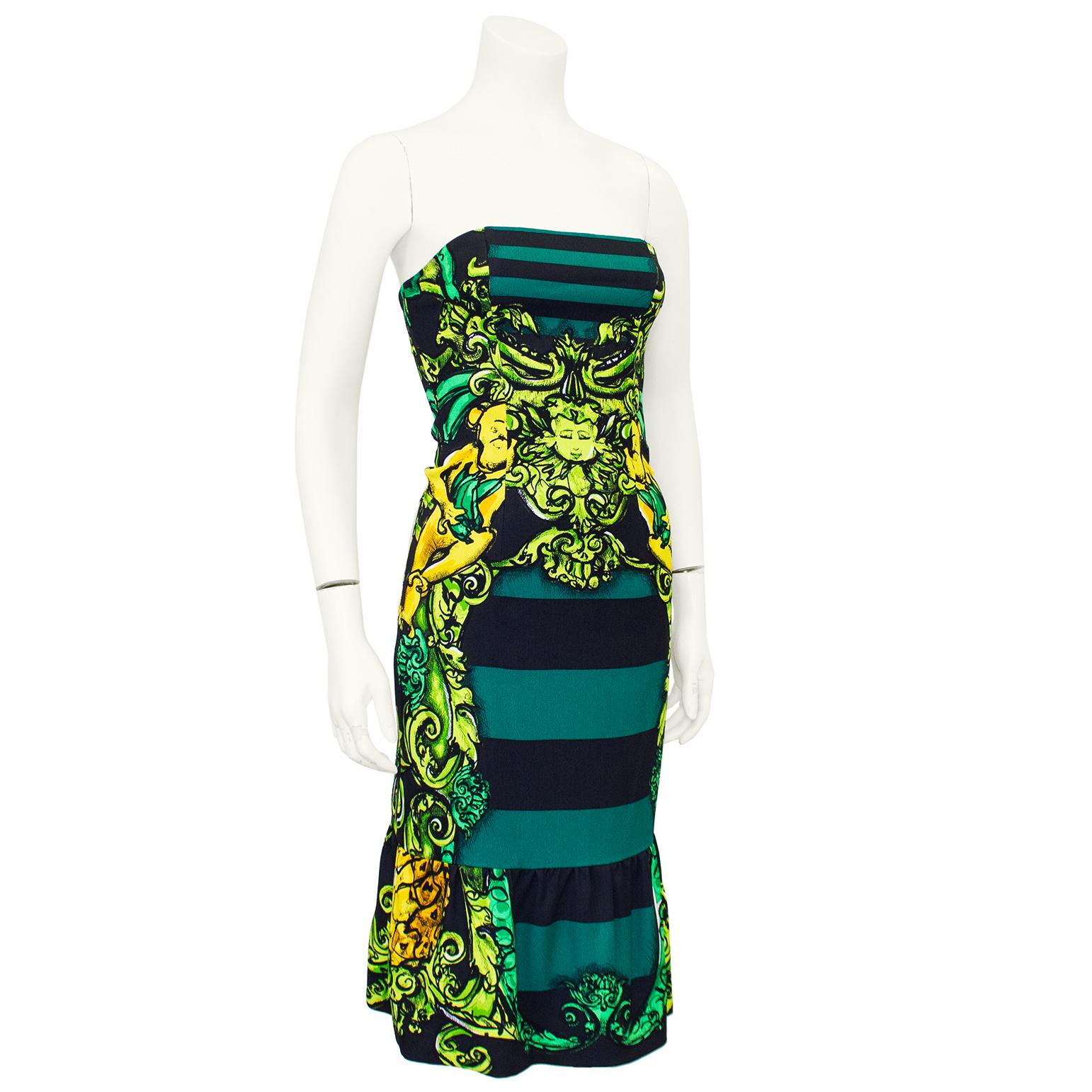 Spring/Summer 2011 Prada printed dress. Green and black horizontal stripe with neon green and yellow cherub, monkey and ornate details throughout. Strapless and fitted through the body and a ruffle skirt. An iconic Prada piece. Worn in the SS 2011