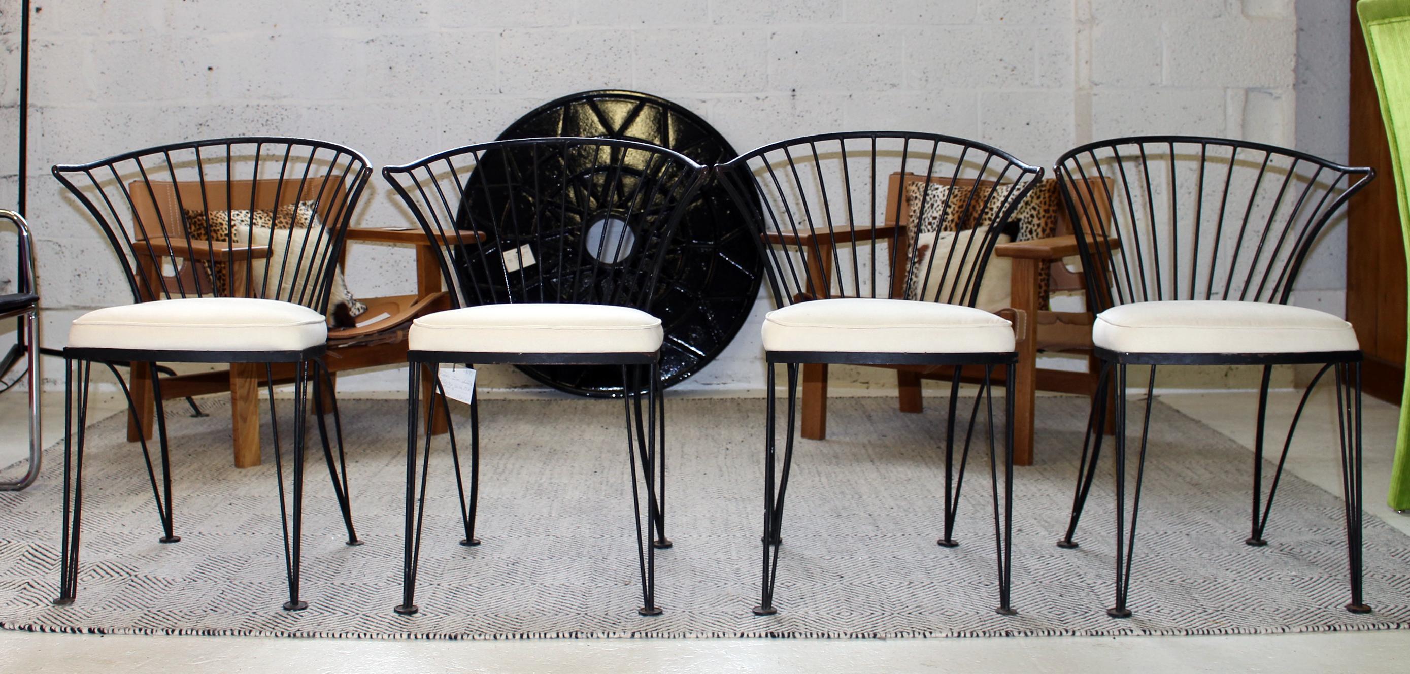 Barrel shaped Salterini black painted wrought iron chairs with muslin covered seat cushion.