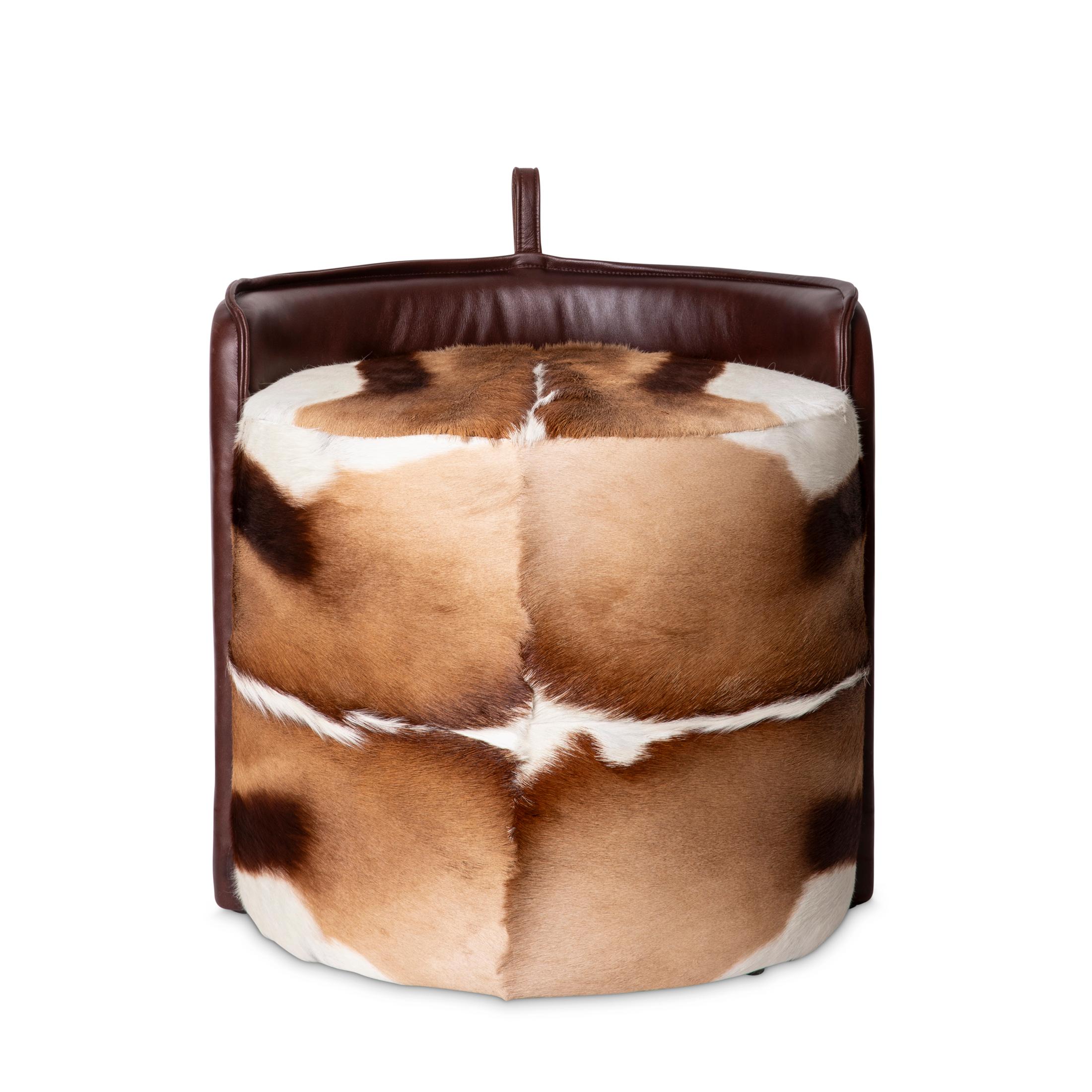 Indulge in the luxury of our Springbok Hide & Leather Stool. Crafted with genuine springbok hide and supple leather, this stool offers both elegance and comfort.   Crafted with a stunning combination of springbok hide and leather, it can be used as