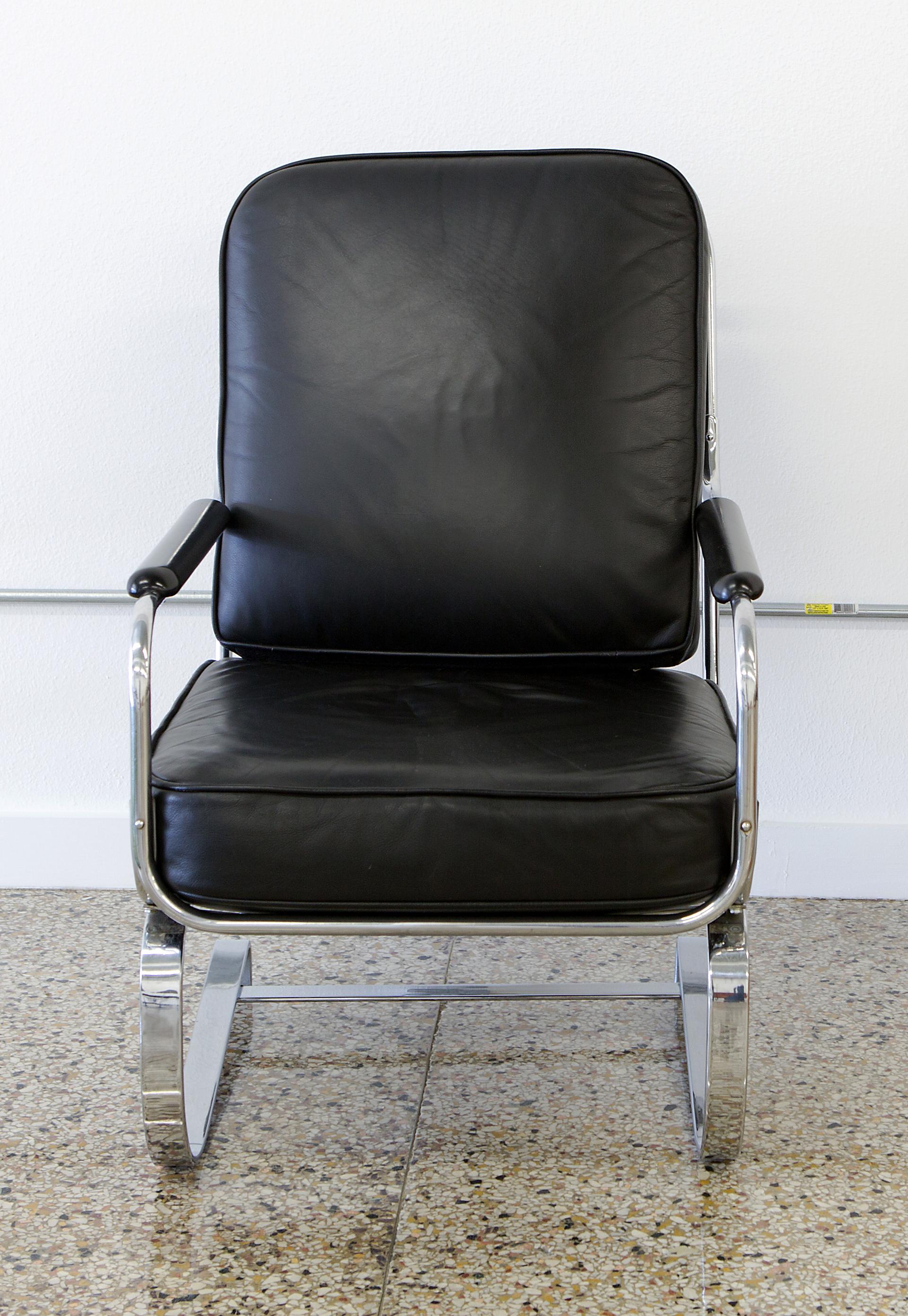 The Springer armchair designed by KEM Weber for Lloyd Manufacturing, circa 1935. Reupholstered in black leather, the beauty of this iconic armchair is its extreme comfort. Sitting upon flat band chrome steel springs, it functions as a rocking chair.