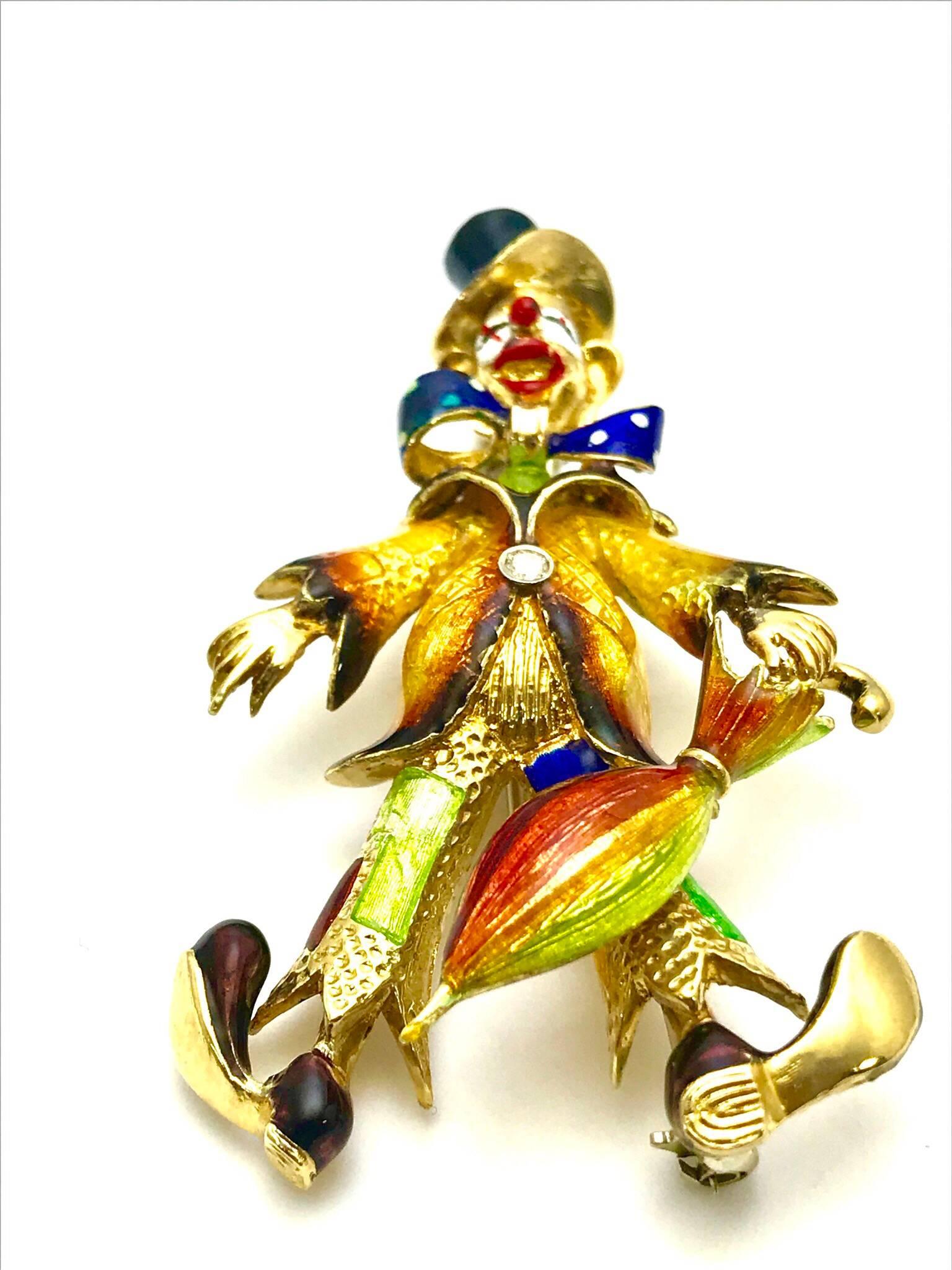 A Spritzer & Fuhrman diamond and enameled 18 karat yellow gold clown brooch.  Standing on the heels of it's clown shoes, with it's toes out, and holding an umbrella, the clown is wearing a top hat, bow tie, coat and clown pants., all enameled with