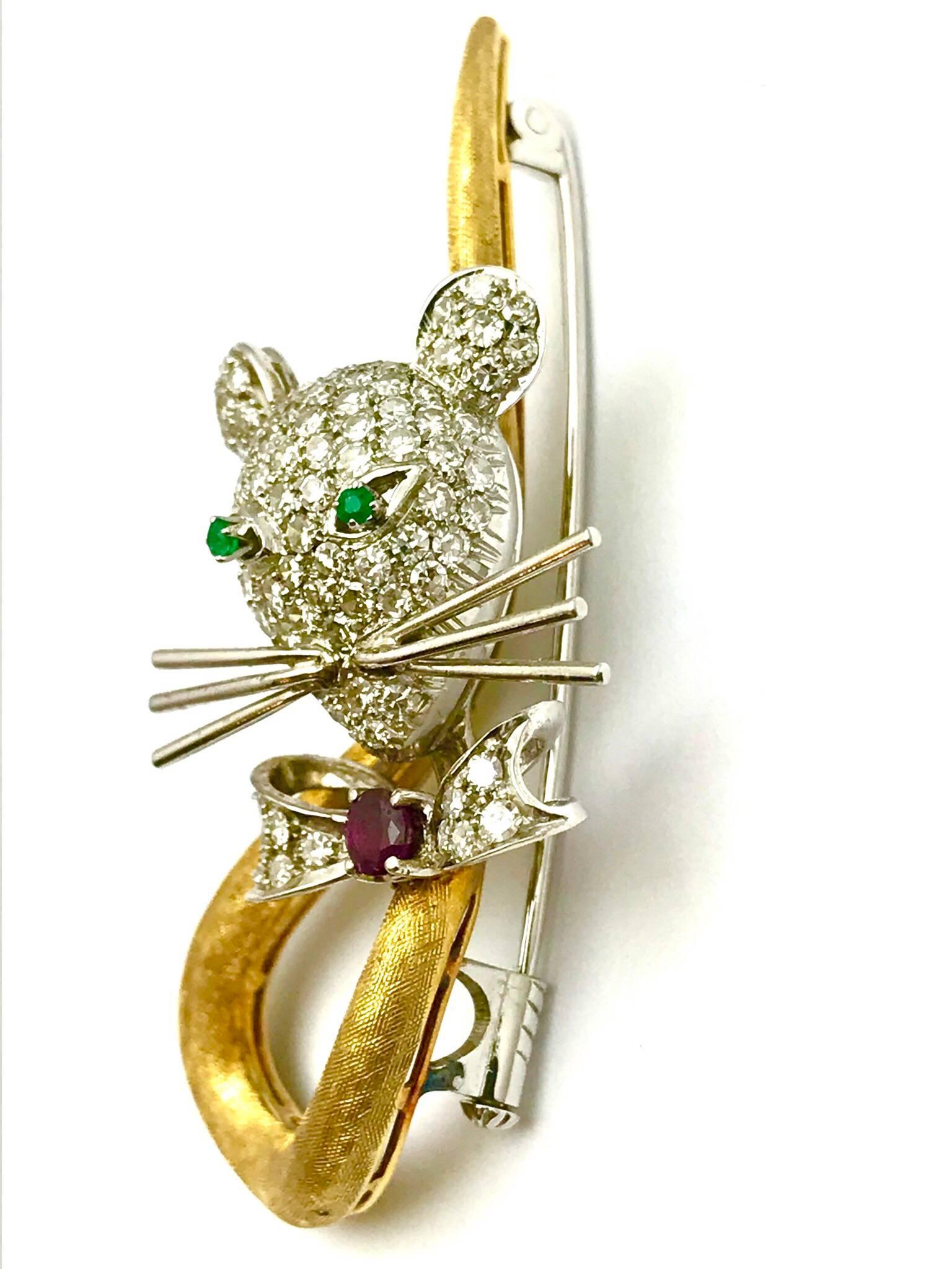 A Spritzer & Fuhrman pave diamond, ruby and emerald 18 karat white and yellow gold circus mouse brooch.  The head, ears and bow tie are pave single cut round diamonds, weighing 1.10 carats total.  The head has six long wire whiskers atop the ruby