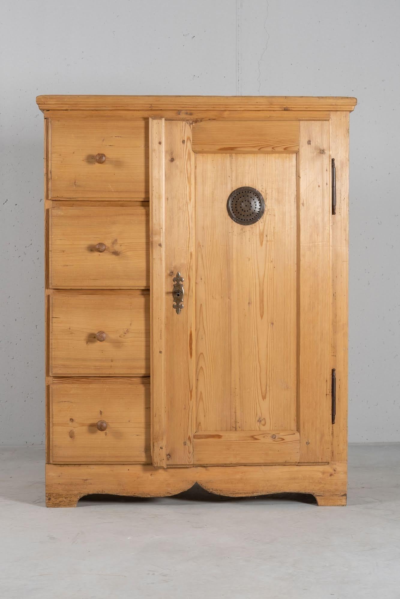 Two parts cupboard, with drawers and a door. Built in solid spruce, with the original hardware.