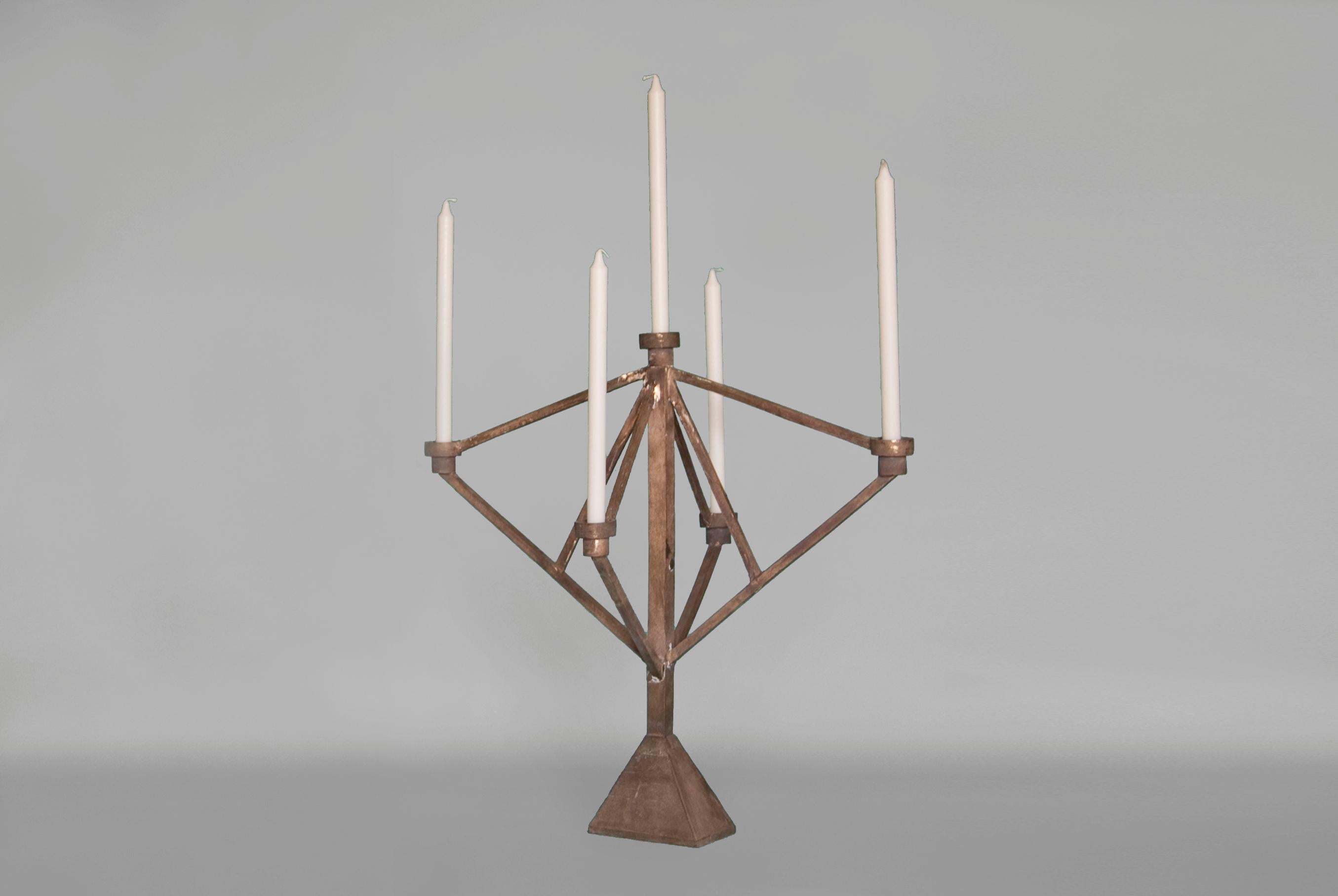 The Sprue candelabra is cast bronze with two-five candleholders depending on the size. The textures within the wax during the casting process translate perfectly into the bronze material, so the castings are left intentionally raw, allowing the