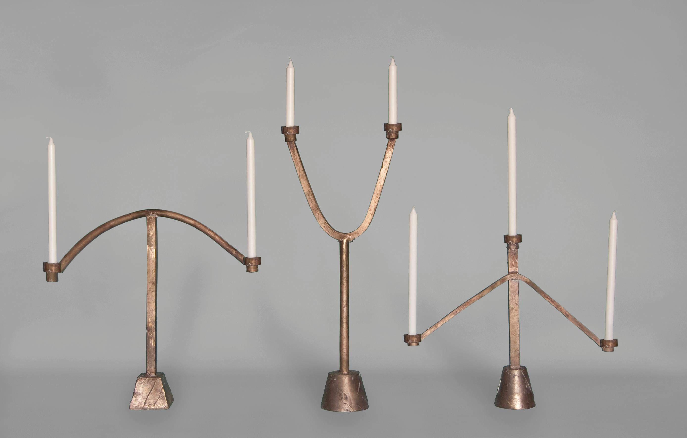 The Sprue 2 candelabra is cast bronze with two candle holders. It is the tallest of the three forms pictured here. The textures within the wax during the casting process translate perfectly into the bronze material, so the castings are left