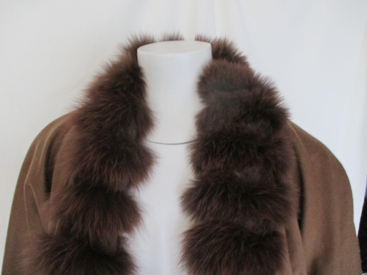 This exclusive vintage cape with sleeves is trimmed with soft fur.

 We offer more luxury fur items, view our frontstore.

Details:
With 2 pockets, 3 closing hooks and sleeves
Its made of a blend wool and cashmere
the fur is trimmed around the