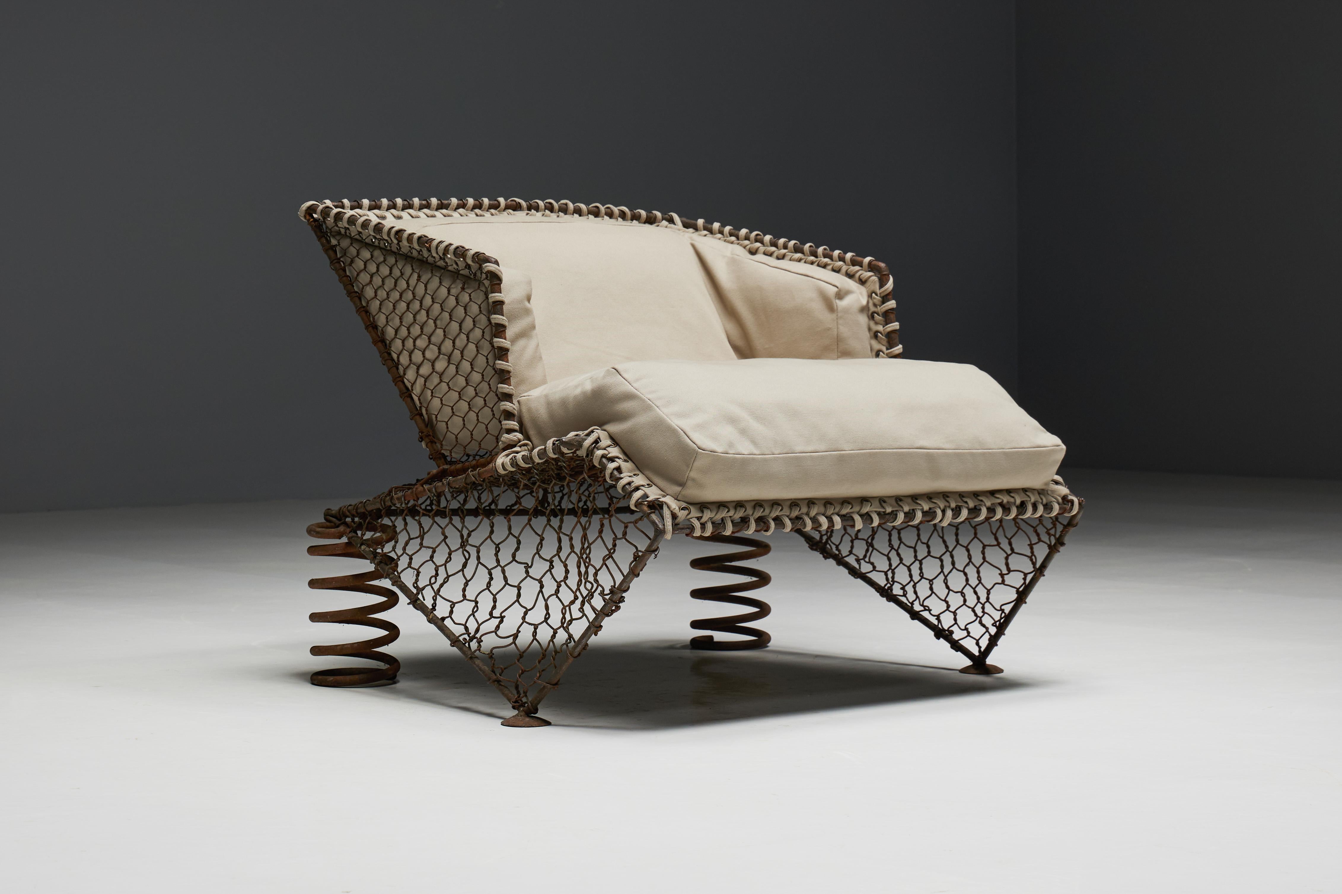 Unique steampunk easy chair, a one-off creation from 1970s France that epitomises artistic innovation with its bold use of metal and whimsical design. The chair features an intricate mesh metal structure complemented by large, coil-sprung legs,