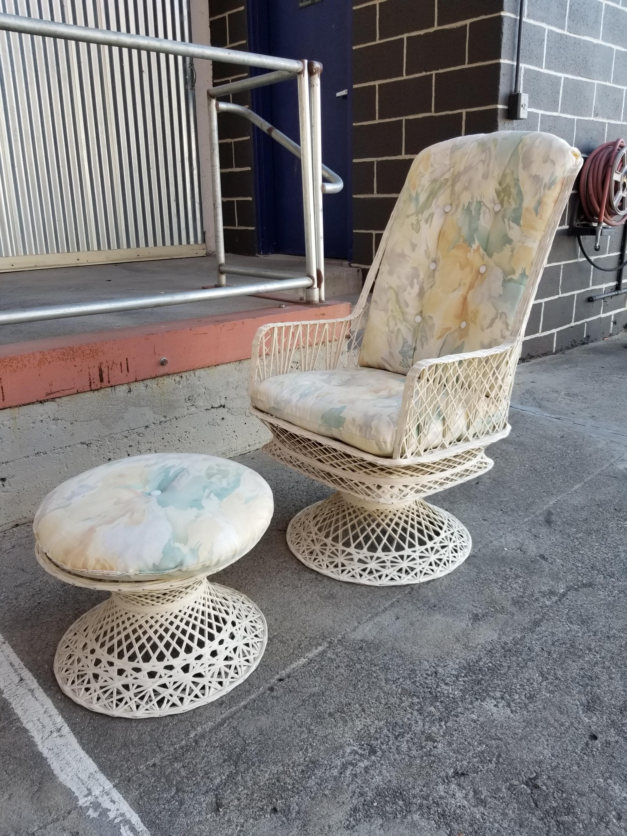 A spun fiberglass swivel lounge chair and footstool with reversible floral seat cushions. Could be enjoyed as indoor or outdoor furniture. Very good original condition, original paint, very sturdy. Ottoman measures: 18.75