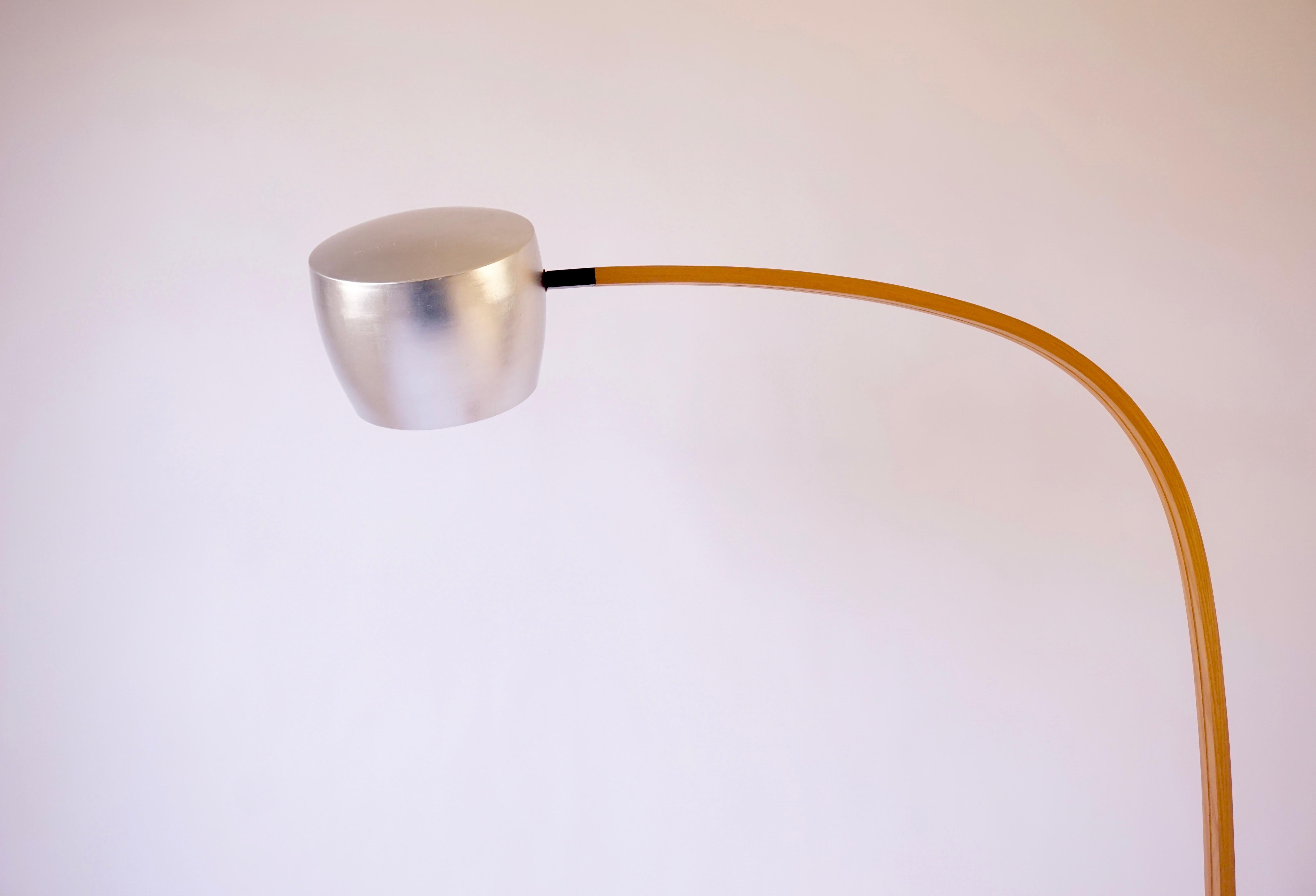 Le lampadaire spun est doté d'un abat-jour en aluminium filé à la main et recouvert d'une couche de poudre blanc os à l'intérieur et à l'extérieur. L'abat-jour est ensuite doré avec une feuille d'aluminium de couleur argentée sur l'extérieur de