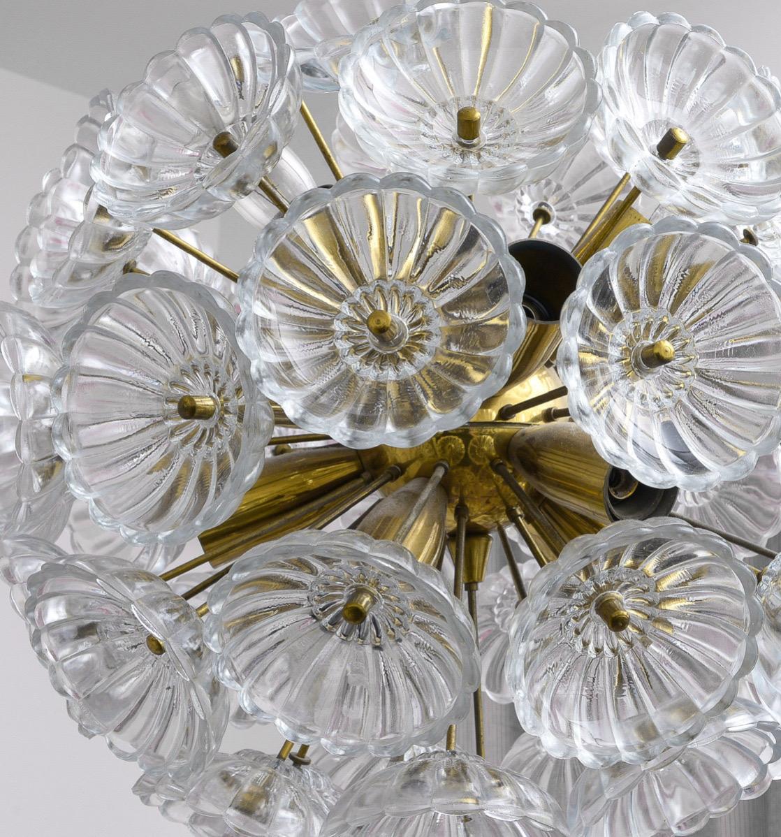 Beautiful Glass Sputnik Light. Made in Germany in the 1960's. Each piece of glass is connected to the base and resembles a flower. 
Beautiful in any room. Especially, kids room, powder room etc...
Elegant and classy.

Same era as: Charlotte
