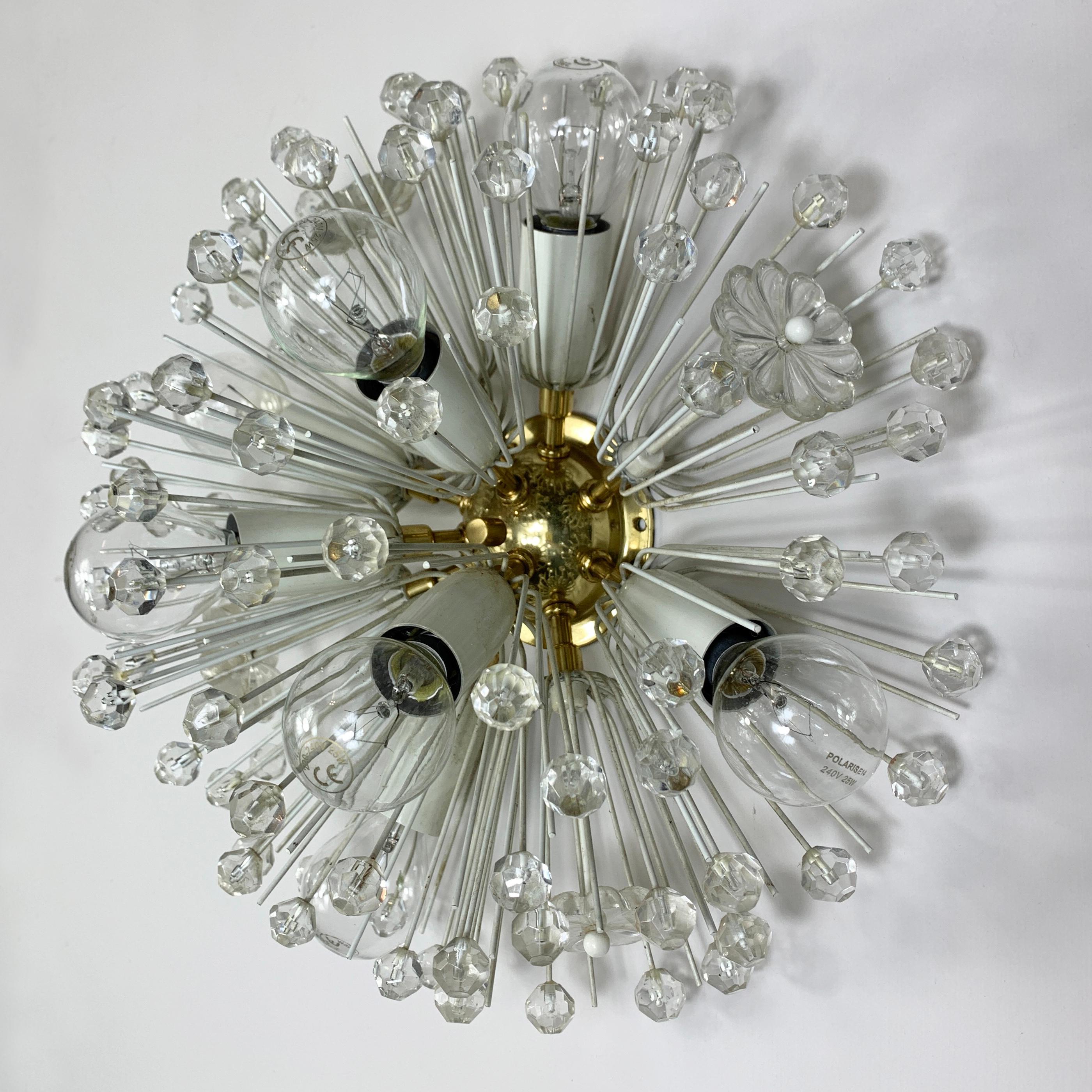 A glorious brass and crystal ceiling pendant, 'Snowball' by Emil Stejnar for the Rupert Nikoll company. Dating to the 1950's this beautiful light is made up of crystal flowers and cut crystal spheres that radiate from the central brass mount. There