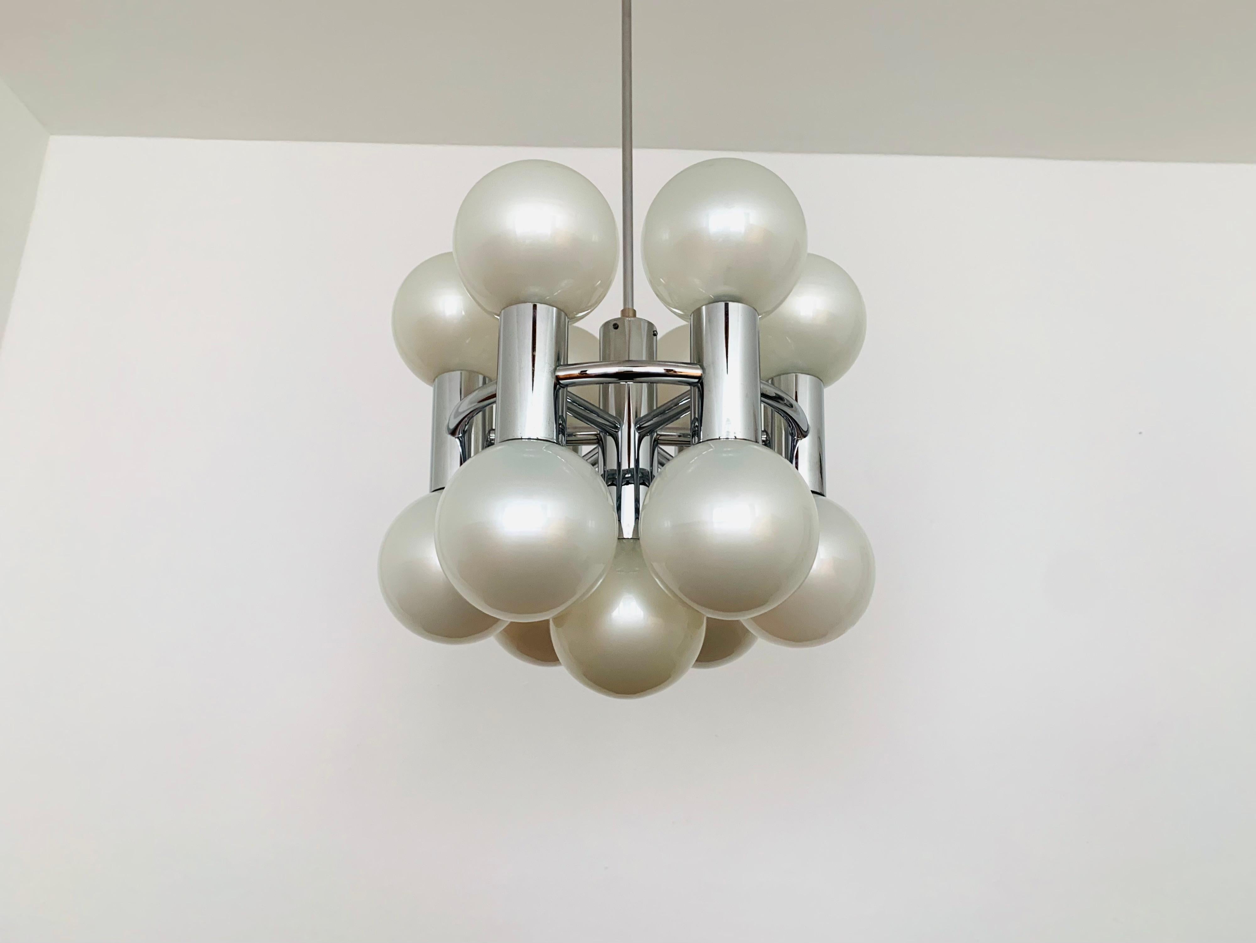 Extremely impressive Sputnik chandelier from the 1970s.
Extraordinary design and a real eye-catcher for every room.
The lighting effect of the lamp is extremely beautiful.
Very high quality processing.
This version with the mother of pearl colored