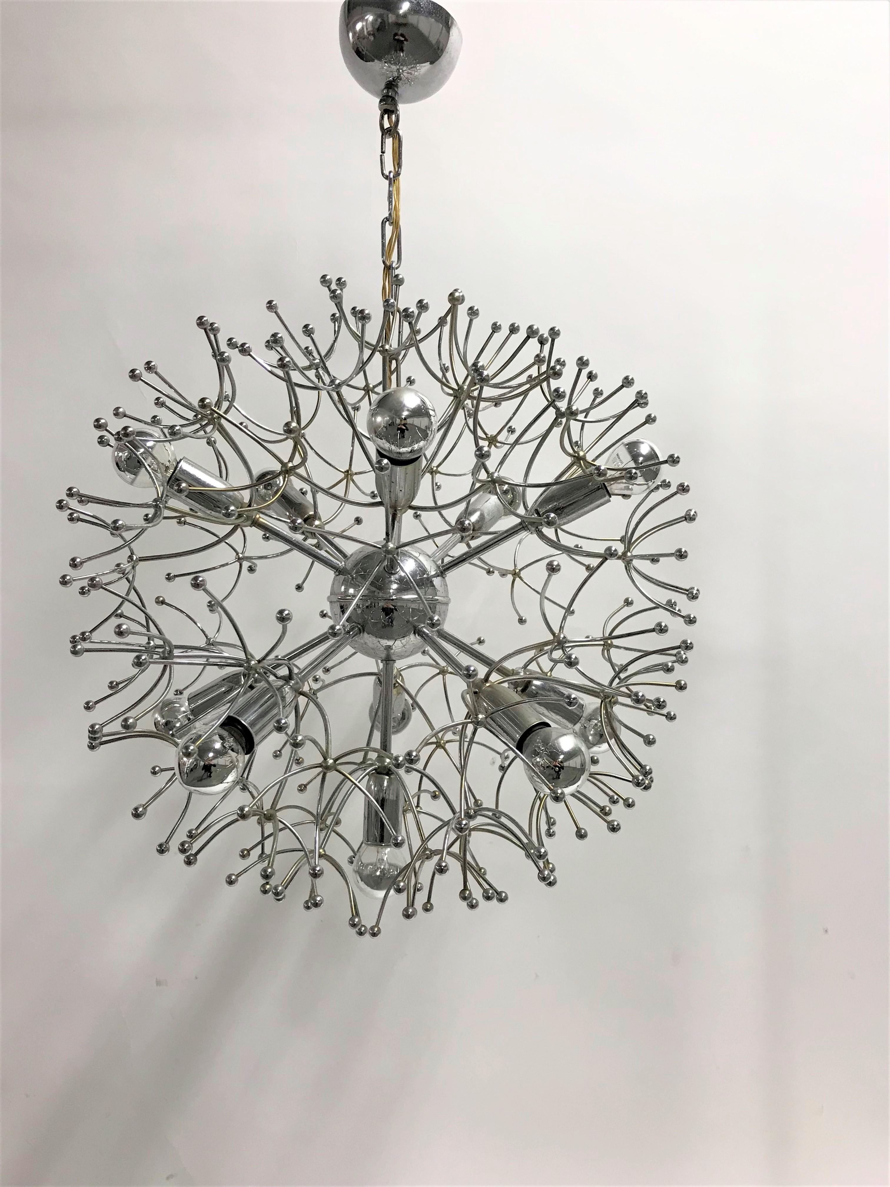 Midcentury chrome sputnik chandelier by Gaetano Sciolari featuring 11 lights.

The lamp emits a spectacular light.

Light patina visible.

Tested and ready for use with regular E14 light bulbs. The chandelier is compatible for all
