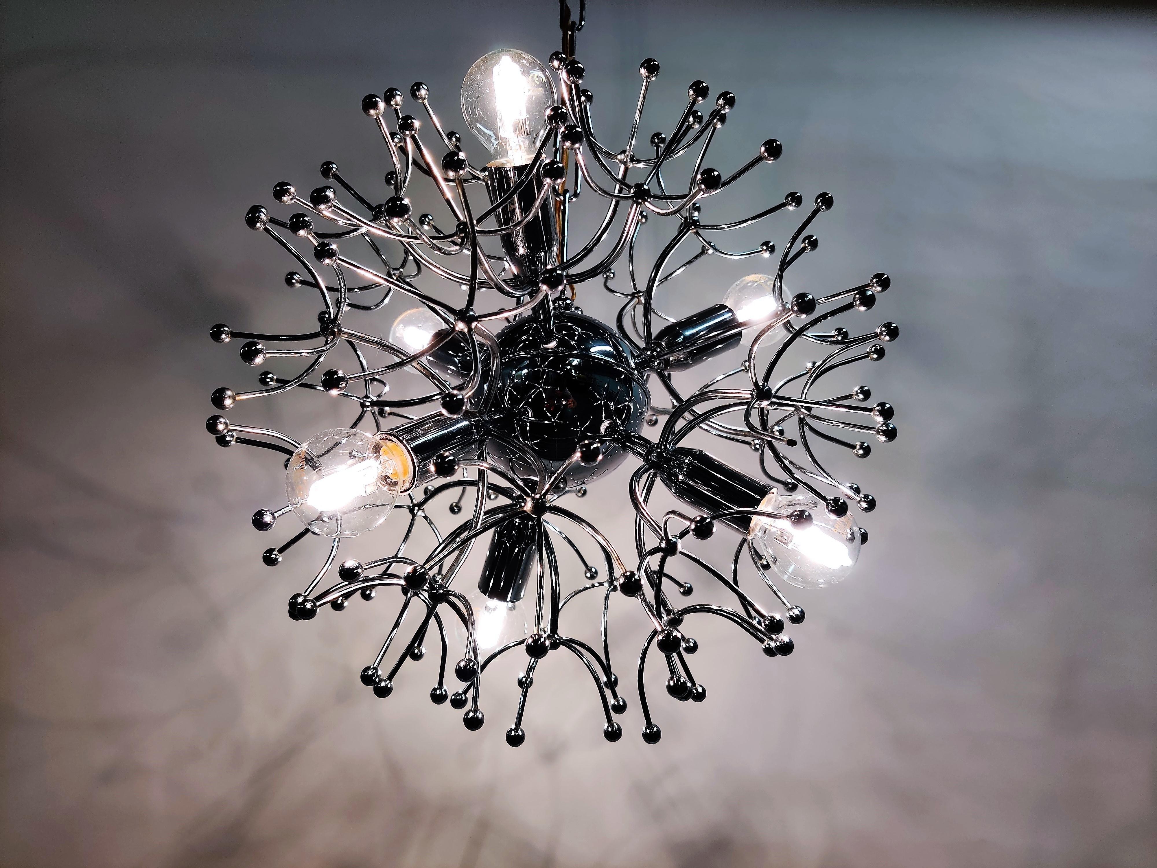 Midcentury chrome sputnik chandelier by Gaetano Sciolari featuring 6 lights.

The lamp emits a spectacular light.

Light patina visible.

Tested and ready for use with regular E14 light bulbs. The chandelier is compatible for all