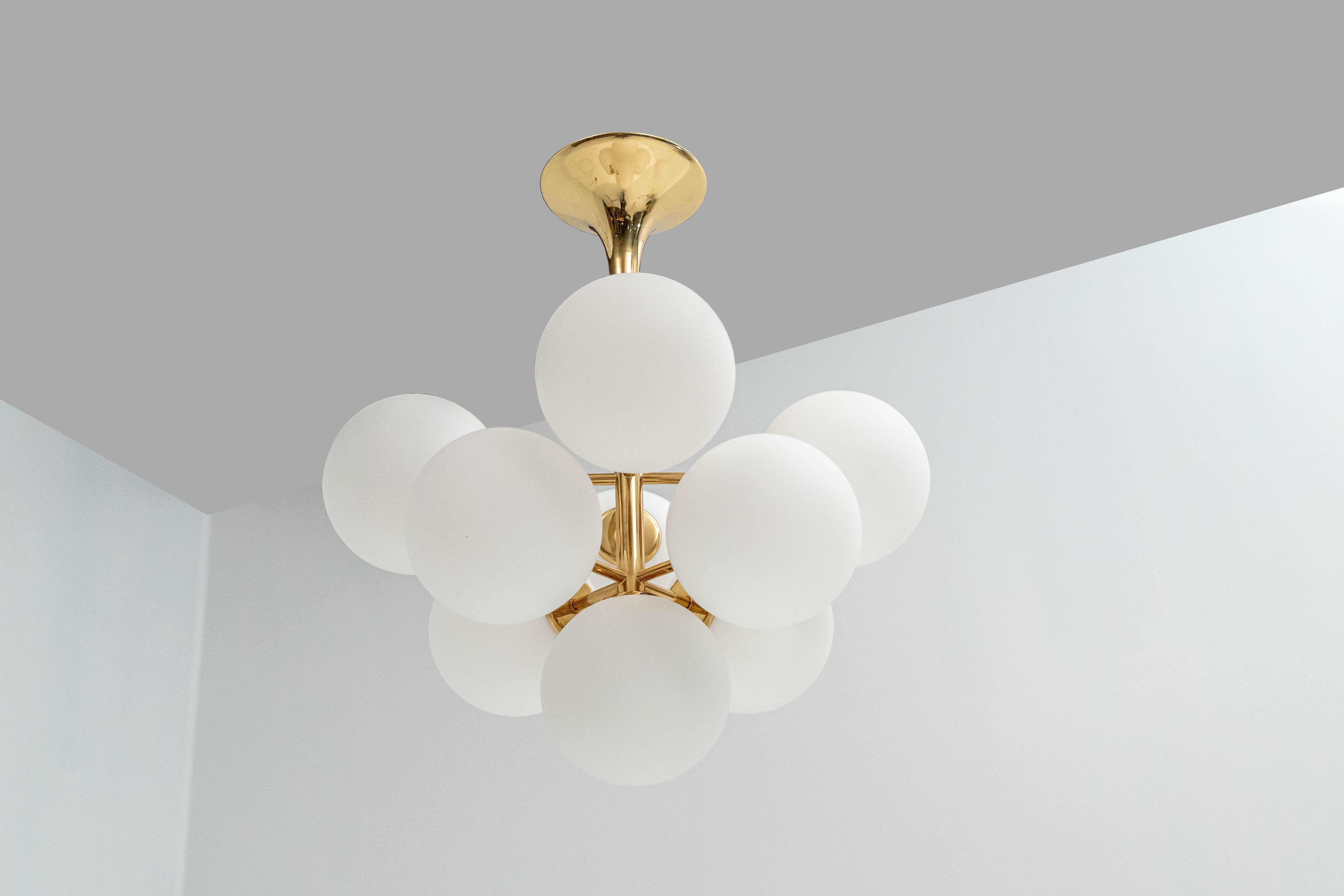 This atomic chandelier with nine white opalescent glass bulbs was designed by the Swiss artist and designer E.R. Nele for Temde Leuchten. The globes are hand blown and fitted with a screwing device. It's a very rare version and very hard to find: