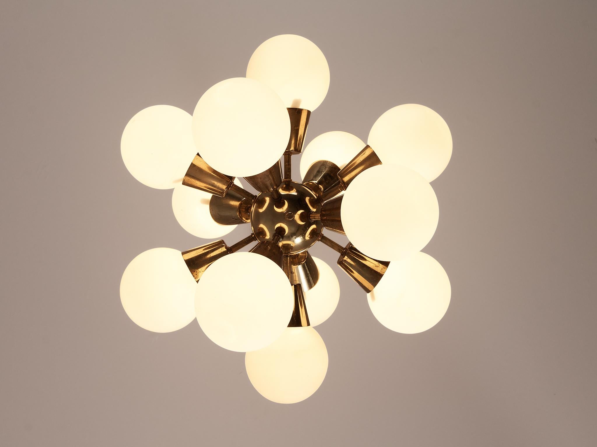 Sputnik chandelier, brass, opaline glass, Europe, 1970s 

This sputnik chandelier features twelve round spheres. Each chandelier consist of a brass fixture with 12 arms, all with a sphere. The frosted glass this lamp creates a nice diffused and soft