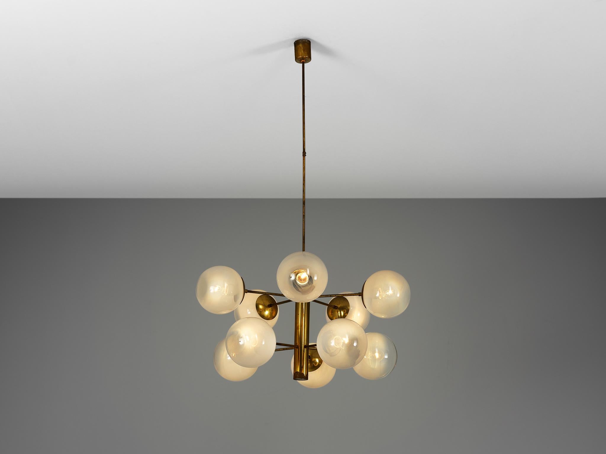 Sputnik chandelier, brass, glass, Europe, 1970s. 

This double layered Sputnik has ten wonderful glass globes. The chandeliers consist of a brass fixture with ten arms, all with a glass sphere. The brass shows an all-over patina. Due the