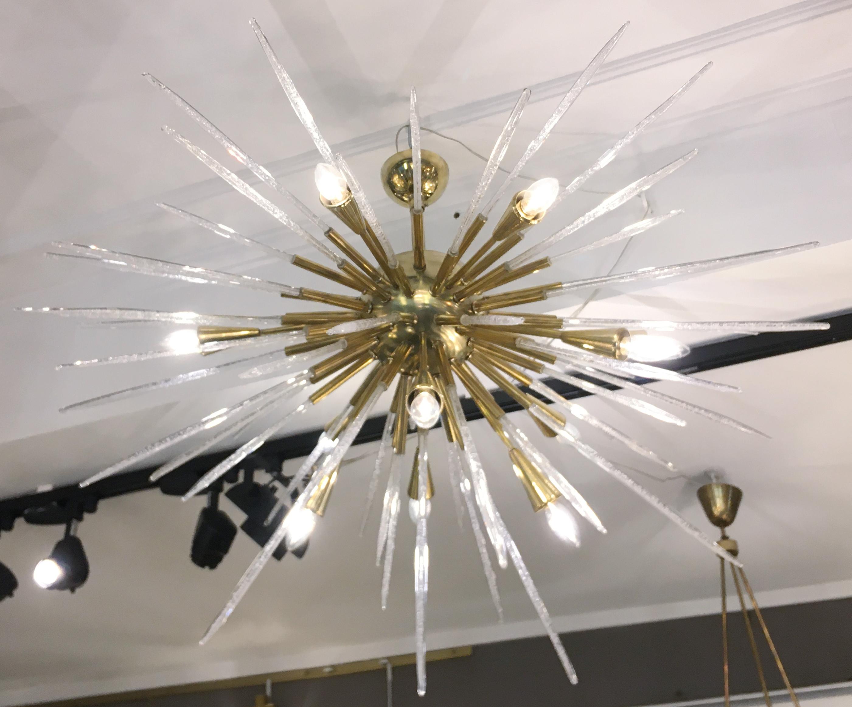 Sputnik chandelier/ceiling light, consisting of a polished brass structure supporting bubble glass 