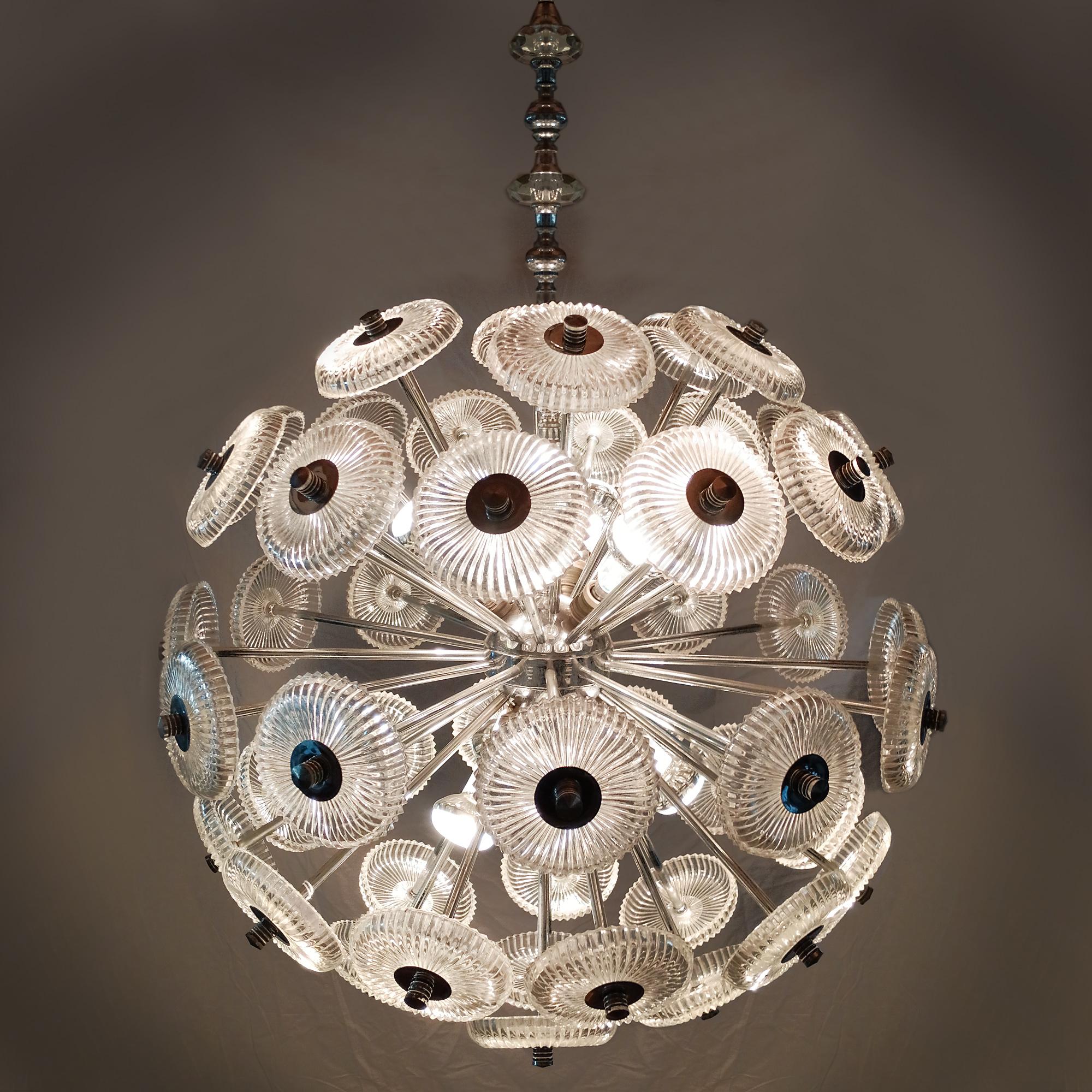 Sputnik chandelier in nickel-plated metal and pressed glass cups. Suspension rod decorated with cut glass cabochons. Six points of light.

Spain c.1950-60.