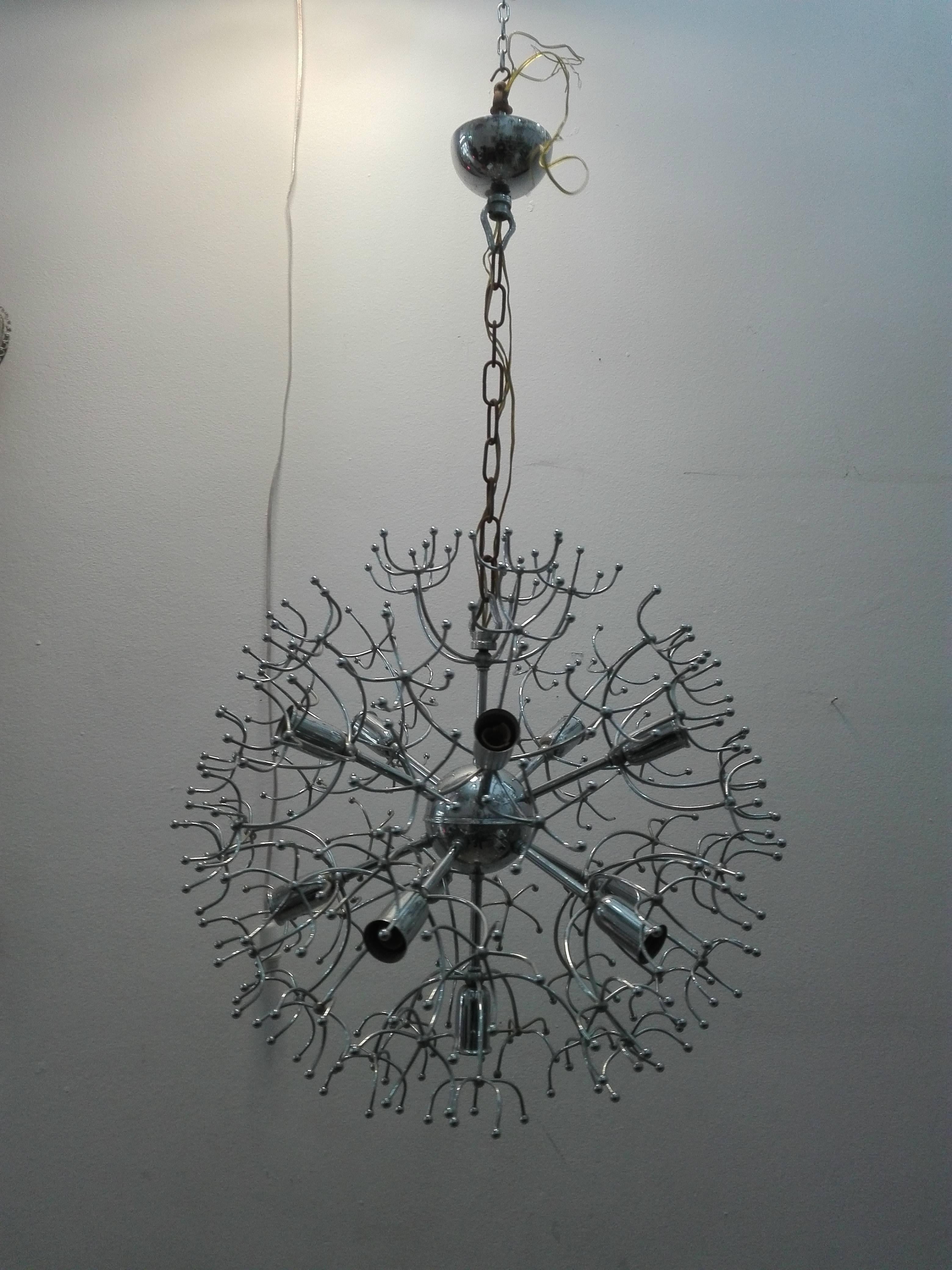 Sputnik chandelier designed by Gaetano Sciolari in the 1960s. The light features in central silver with 11 arms with 11 bulbs attached. Each stem has five smaller stems and then a further five stems.
